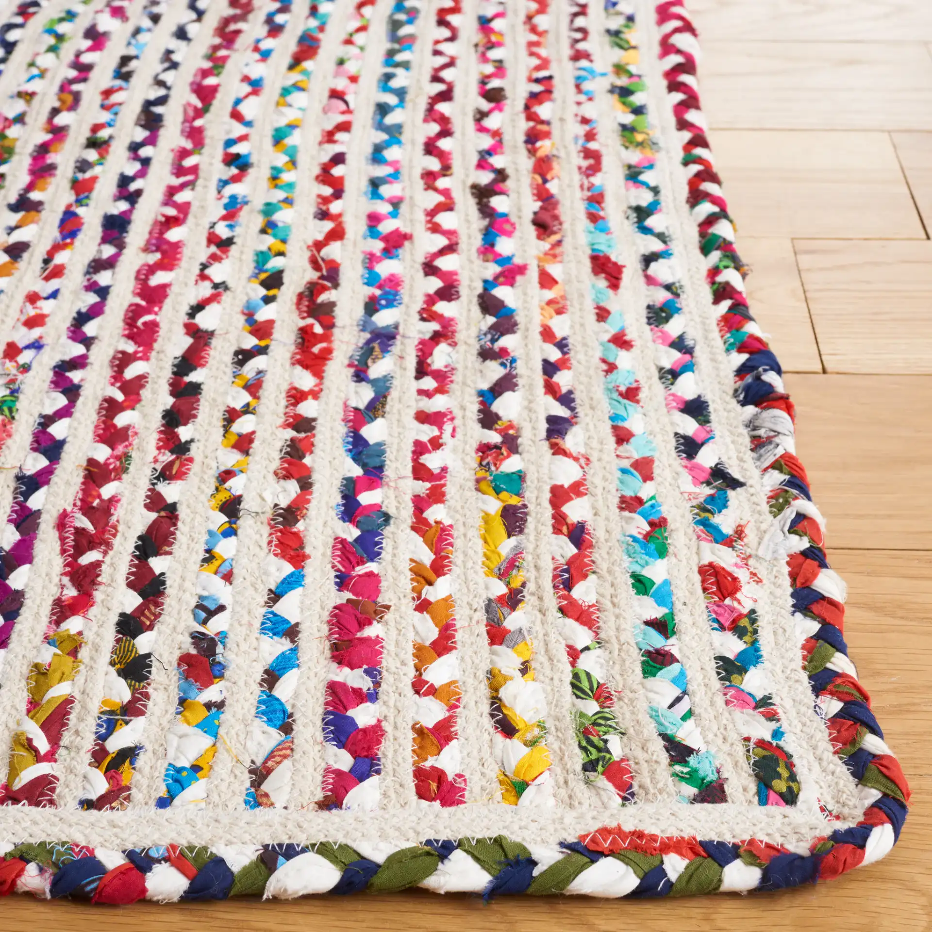 Braided Coastal Stripe Cotton Rug in Ivory / Multicolor in a styled room