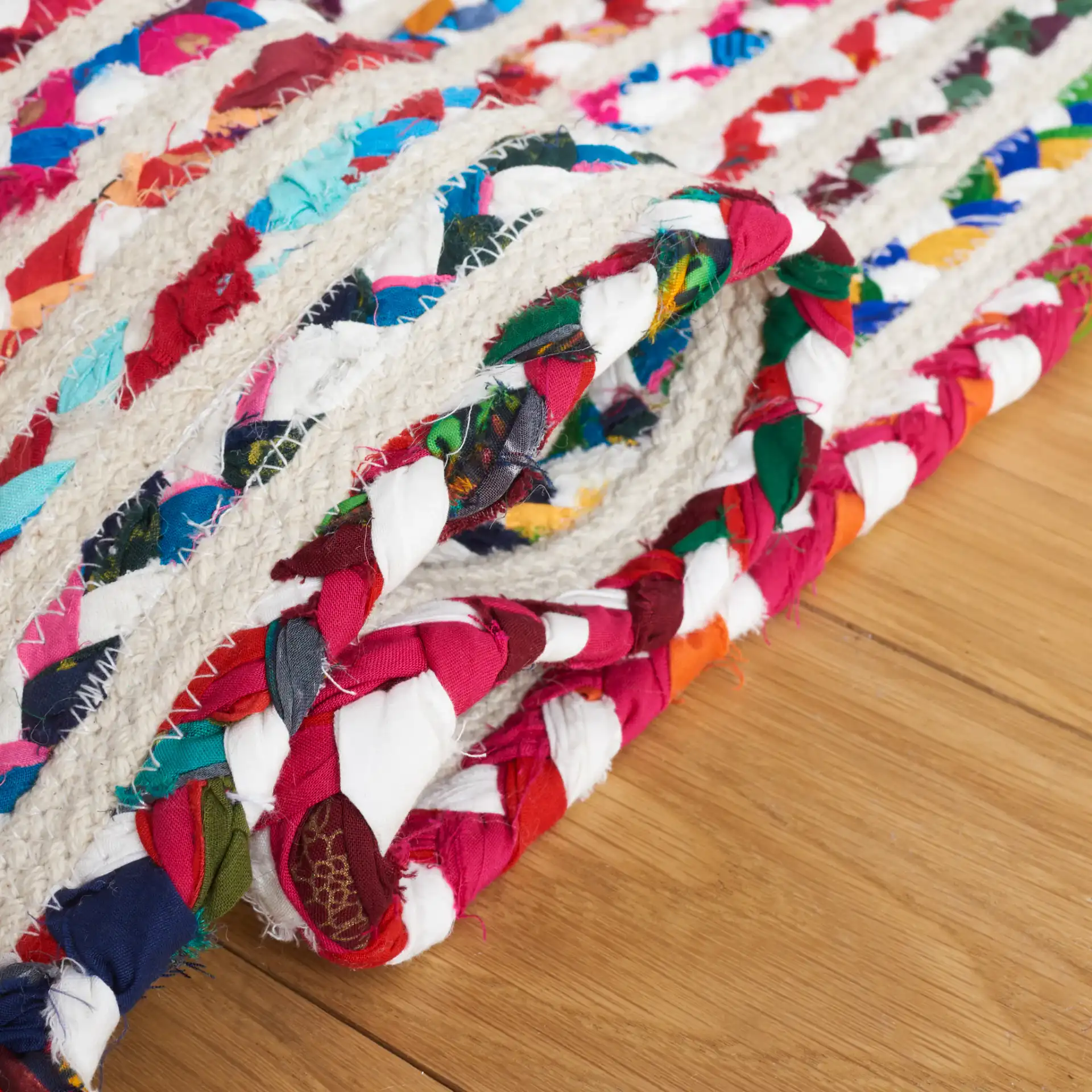 Braided Coastal Stripe Cotton Rug in Ivory / Multicolor in a styled room
