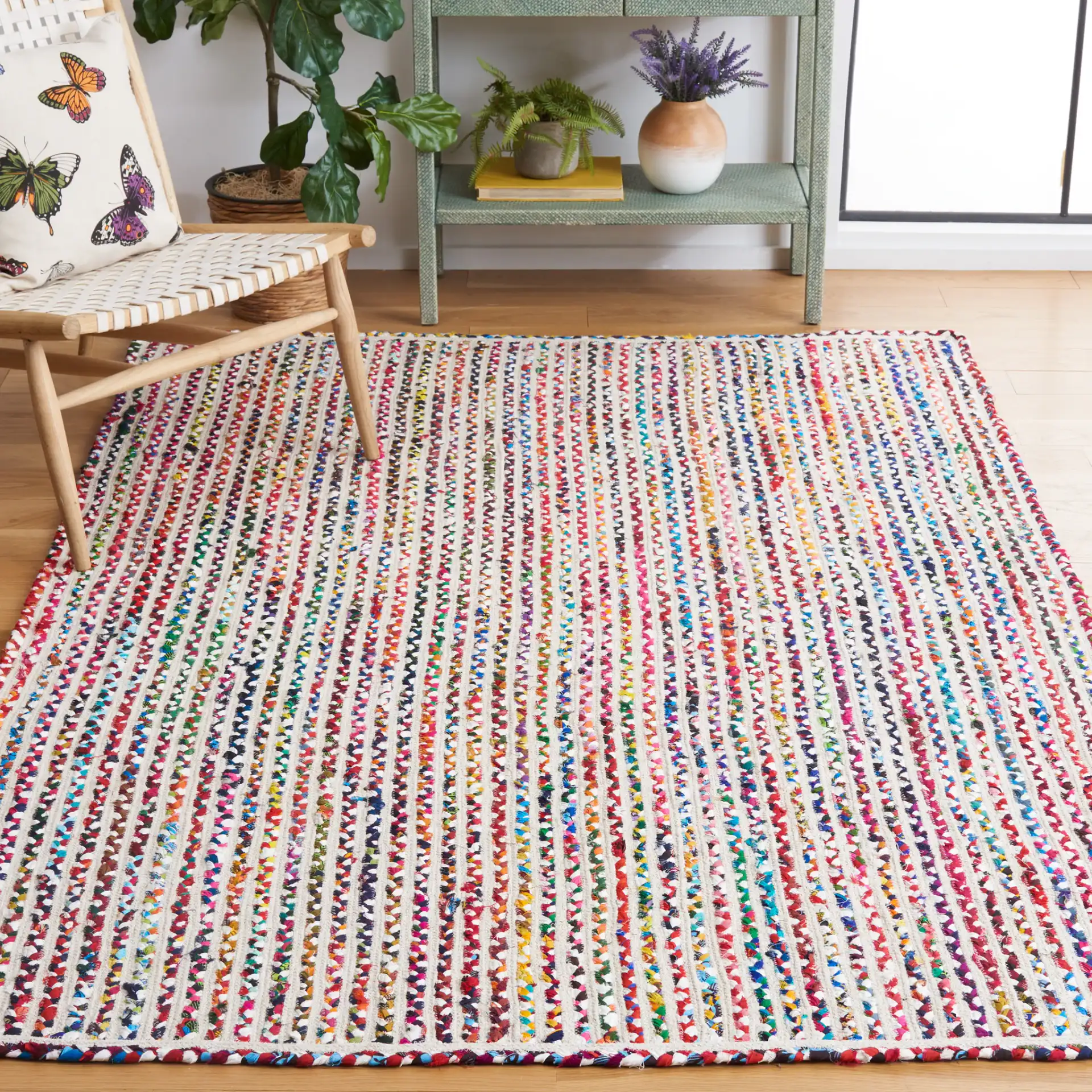 Braided Coastal Stripe Cotton Rug in Ivory / Multicolor in a styled room