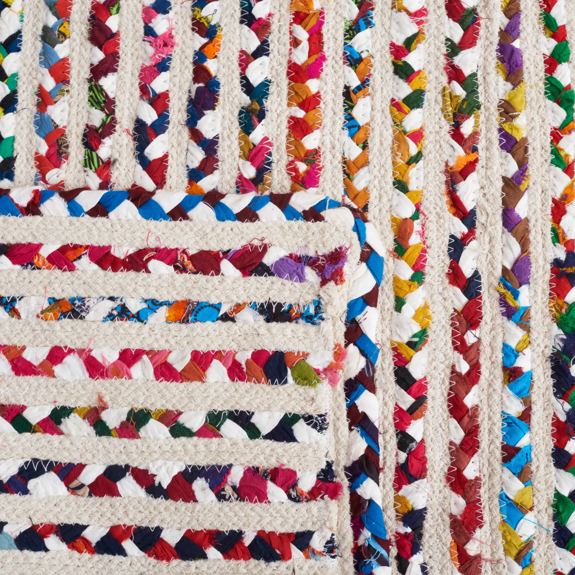 Braided Coastal Stripe Cotton Rug in Ivory / Multicolor in a styled room