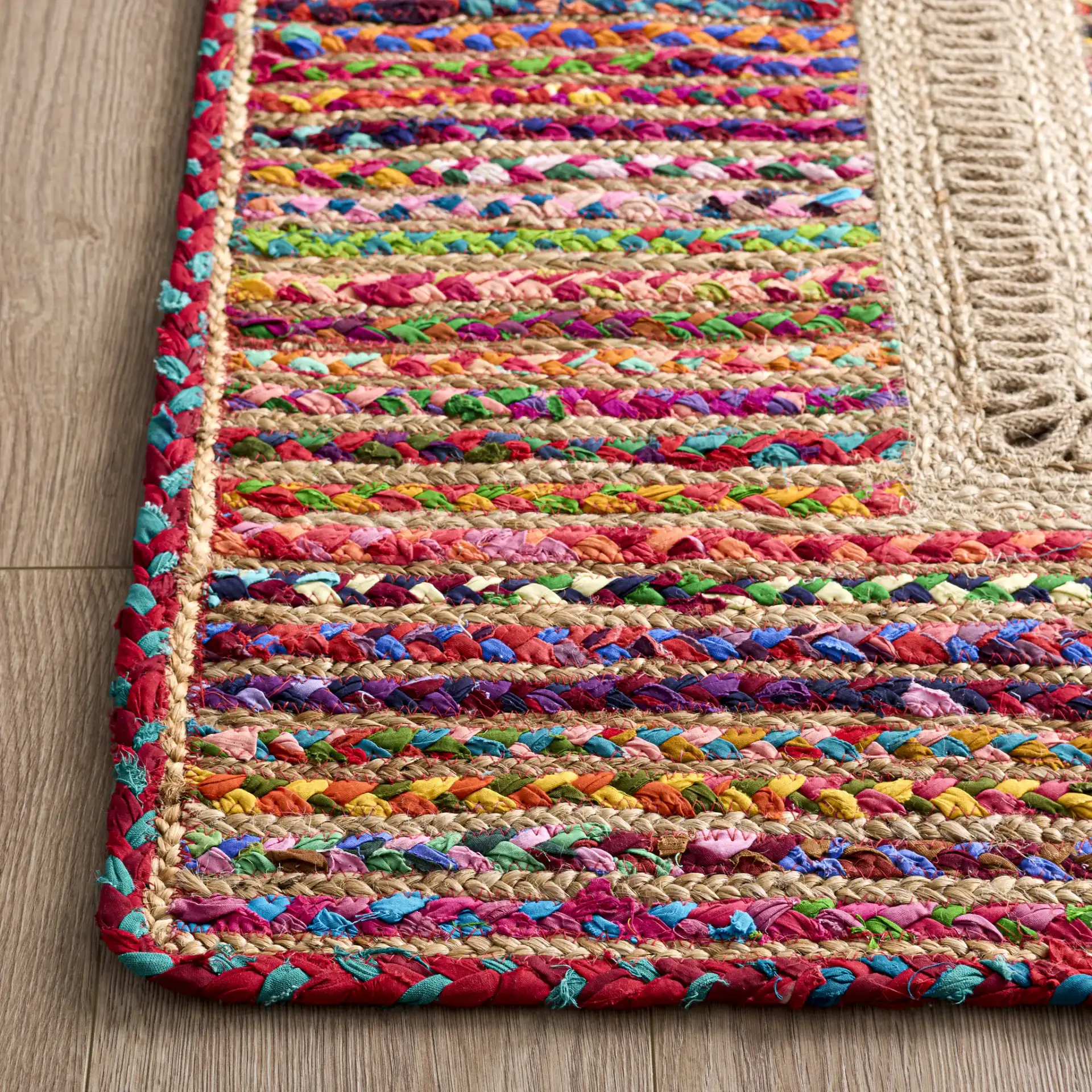 Braided Coastal Geometric Cotton & Jute Hand-Woven Rug in Pink / Sage in a styled room