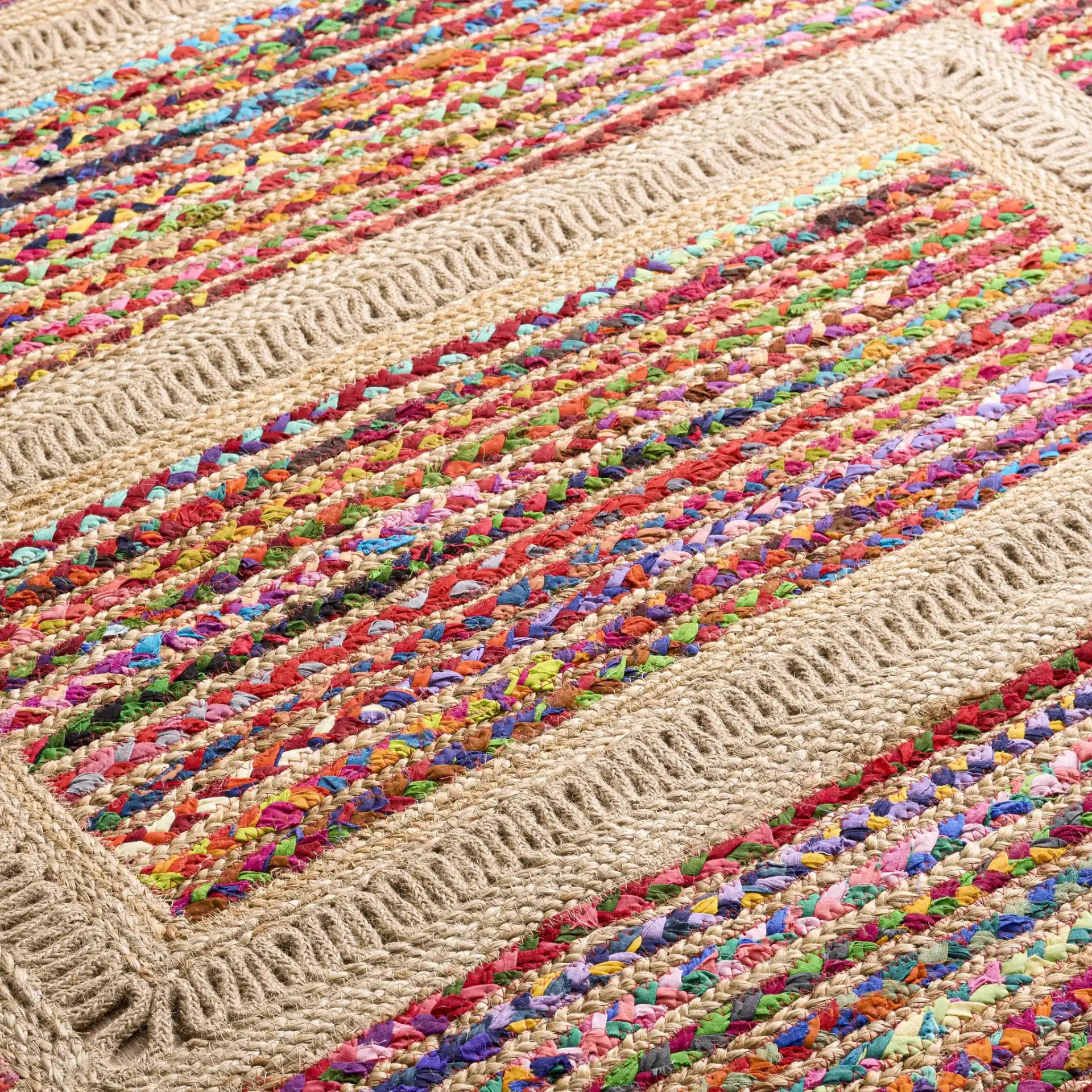 Braided Coastal Geometric Cotton & Jute Hand-Woven Rug in Pink / Sage in a styled room