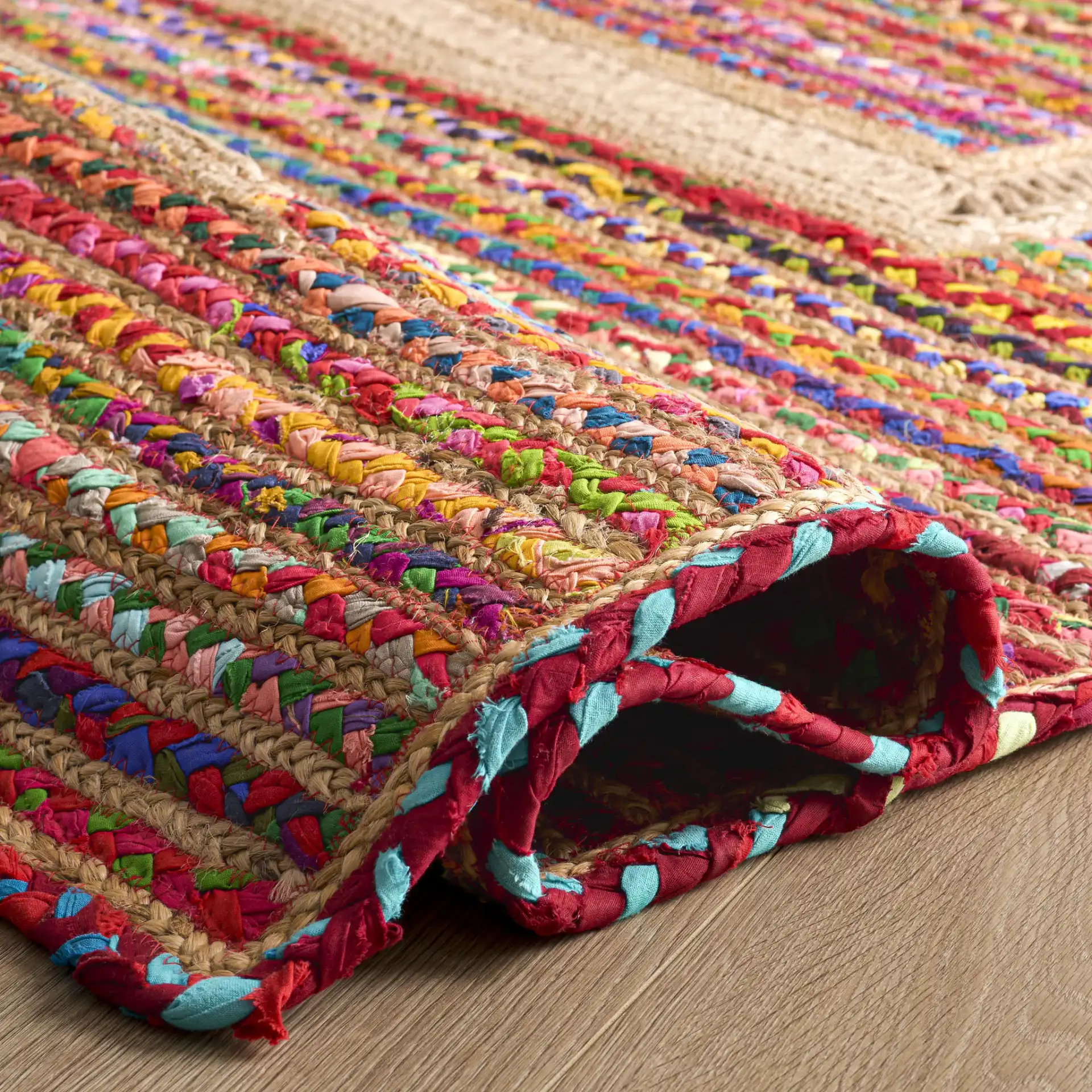 Braided Coastal Geometric Cotton & Jute Hand-Woven Rug in Pink / Sage in a styled room