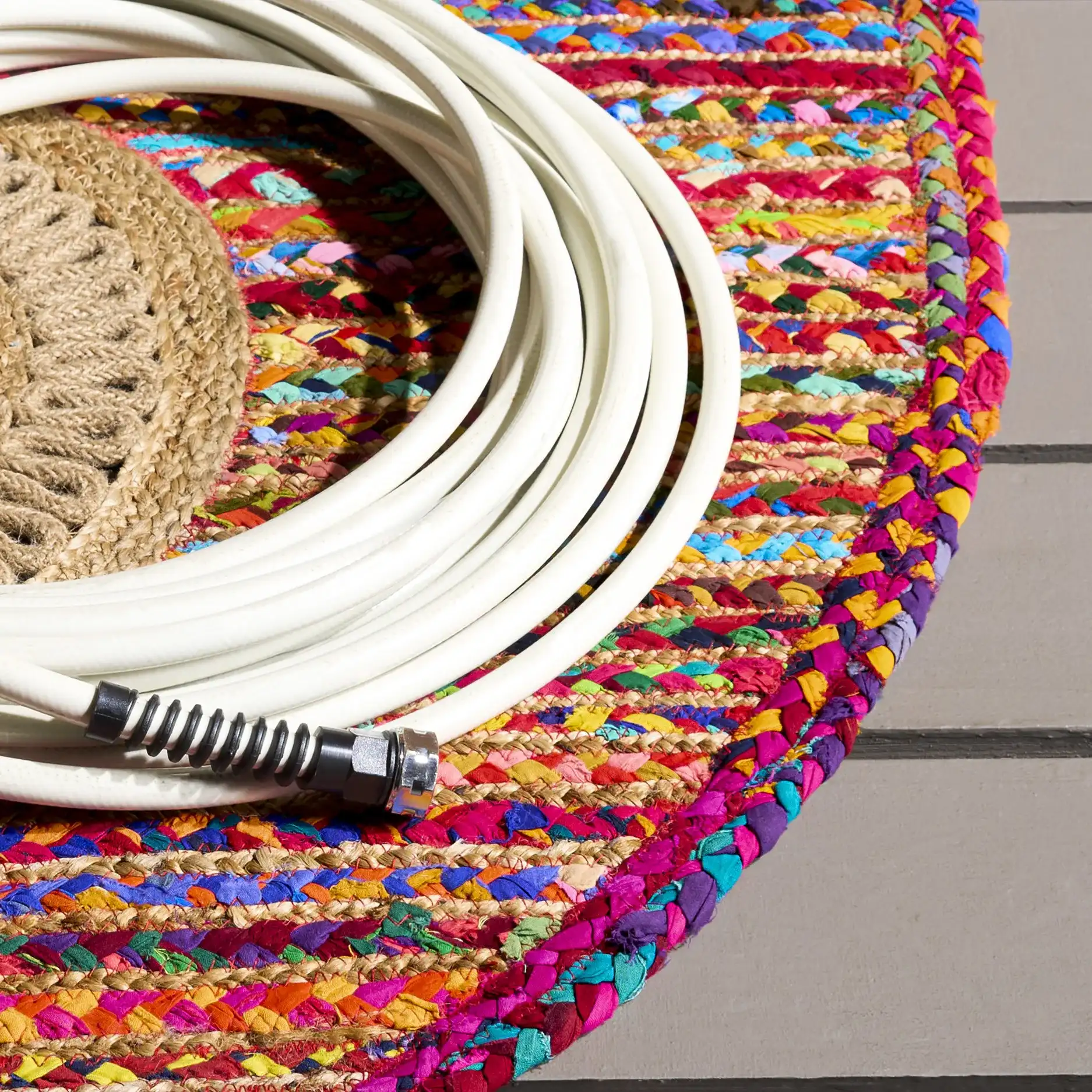 Braided Coastal Geometric Cotton & Jute Hand-Woven Rug in Pink / Sage in a styled room