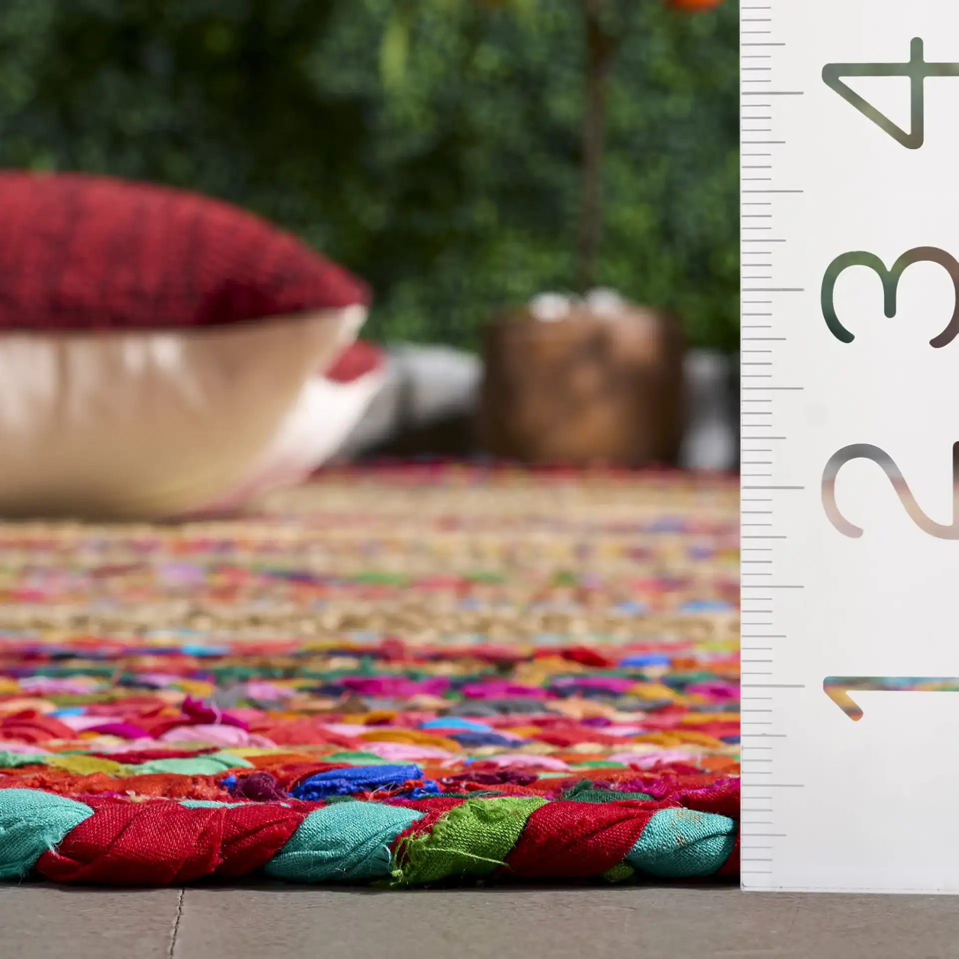 Braided Coastal Geometric Cotton & Jute Hand-Woven Rug in Pink / Sage in a styled room