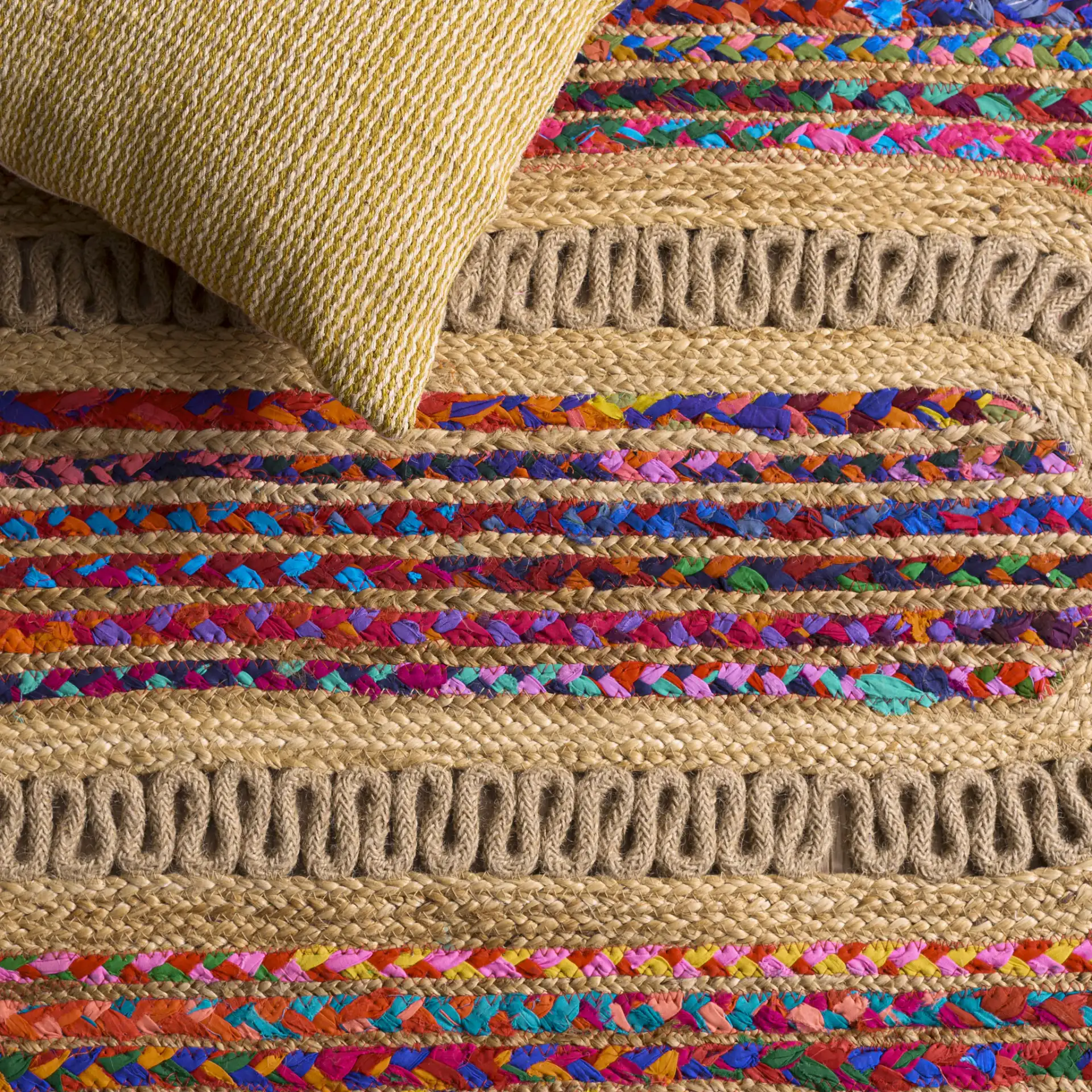 Braided Coastal Geometric Cotton & Jute Hand-Woven Rug in Pink / Sage in a styled room