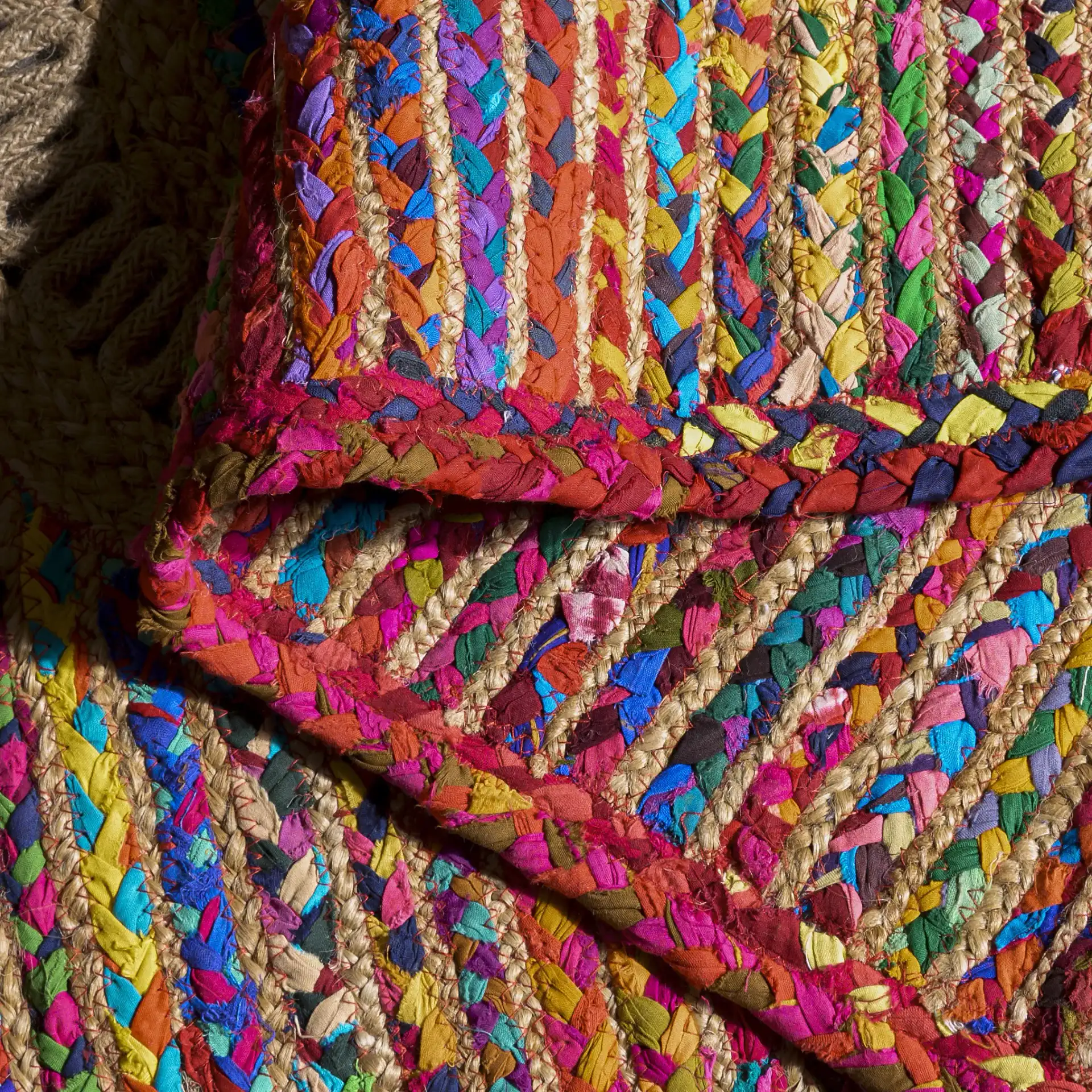 Braided Coastal Geometric Cotton & Jute Hand-Woven Rug in Pink / Sage in a styled room