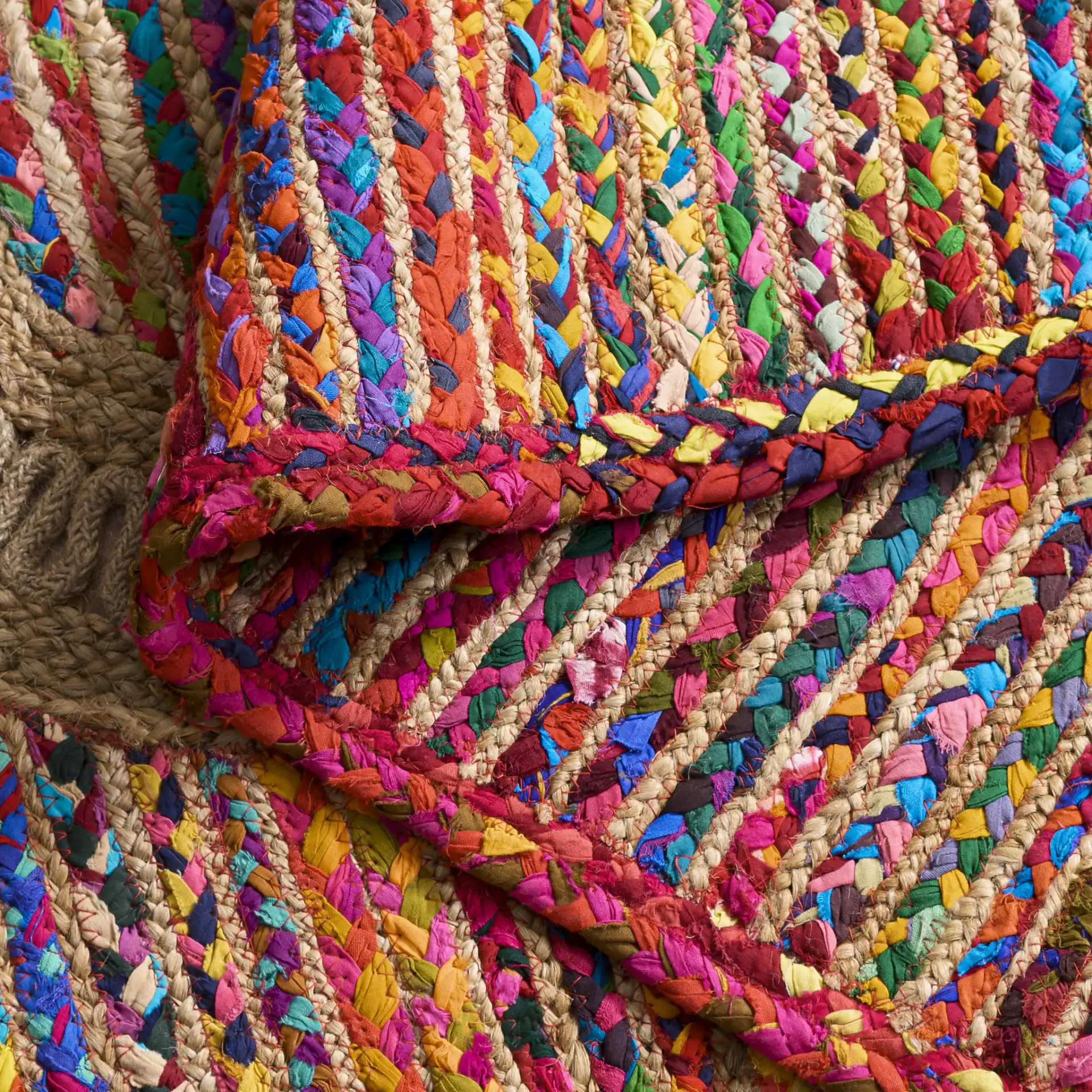 Braided Coastal Geometric Cotton & Jute Hand-Woven Rug in Pink / Sage in a styled room