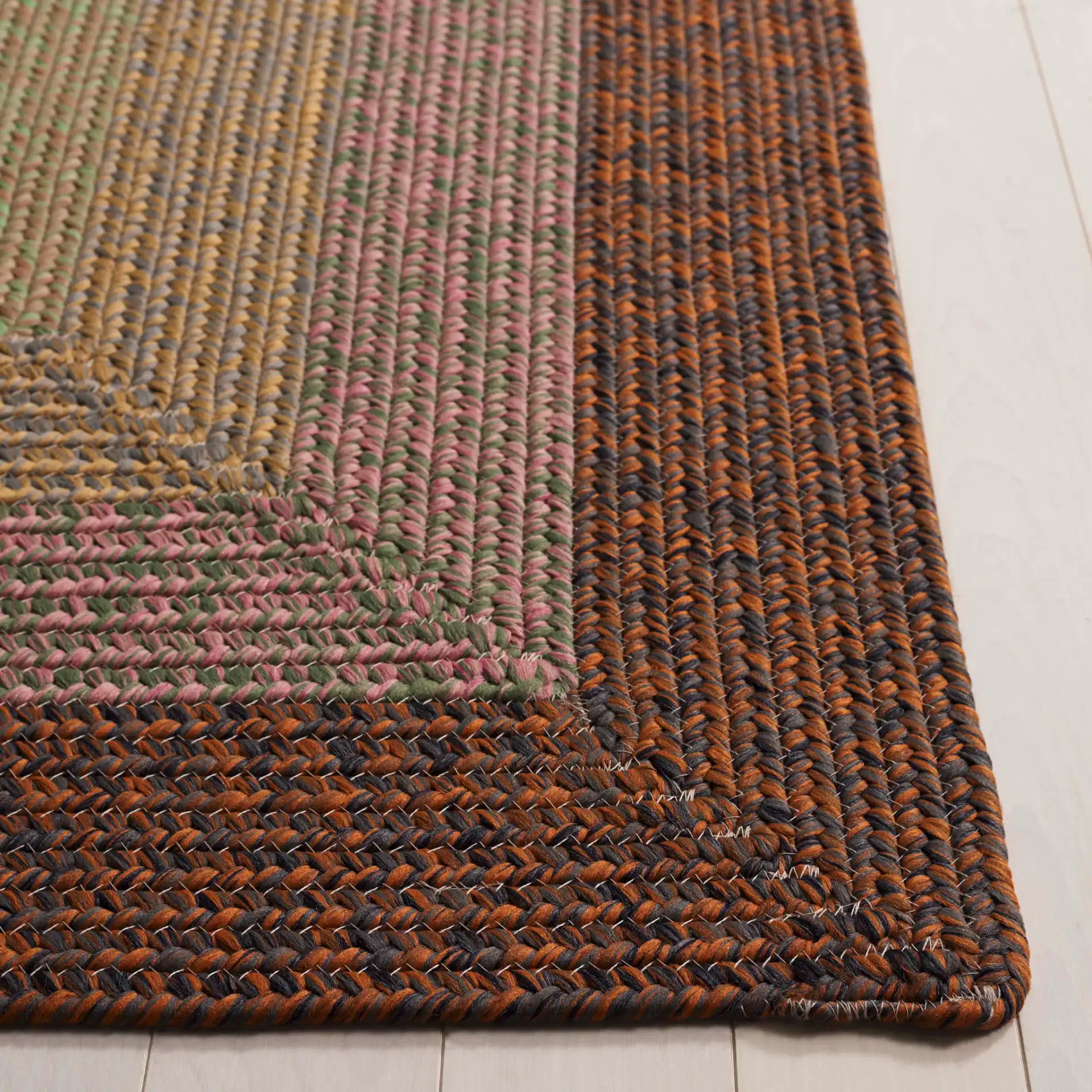Braided Oval Band Washable Outdoor Rug in Dark Brown / Light Green in a styled room