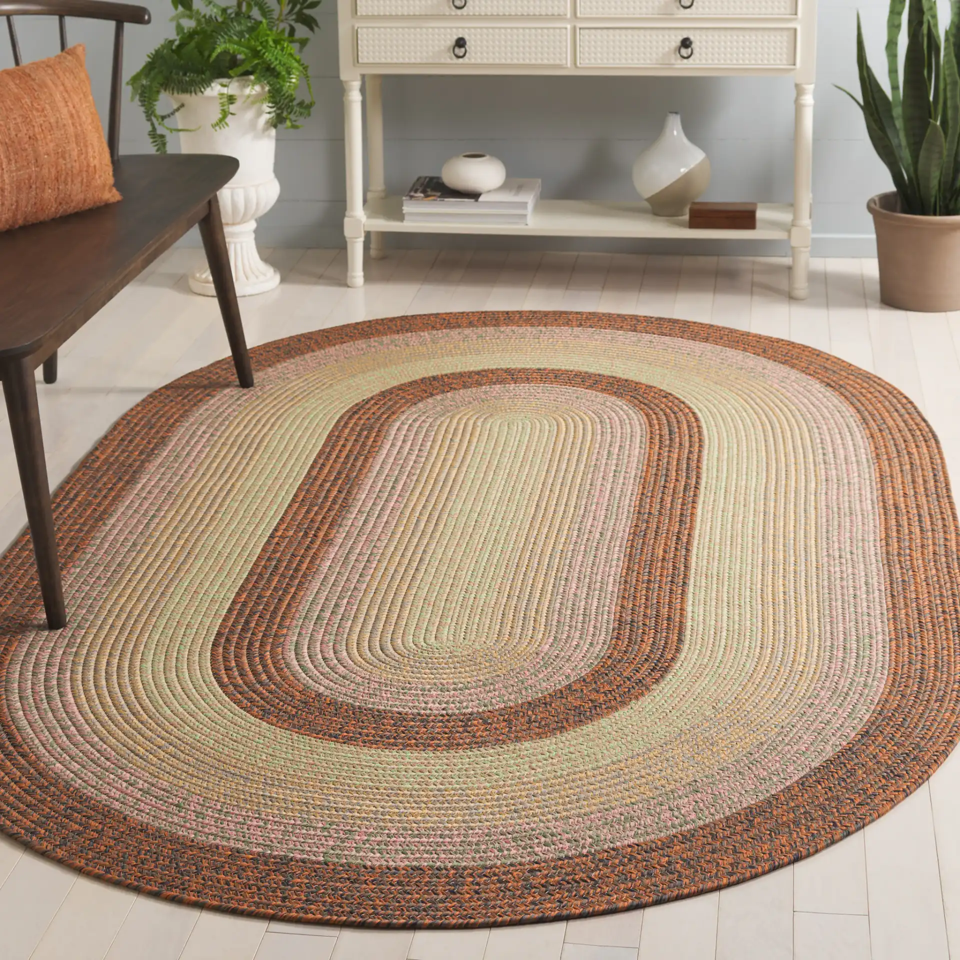 Braided Oval Band Washable Outdoor Rug in Dark Brown / Light Green in a styled room