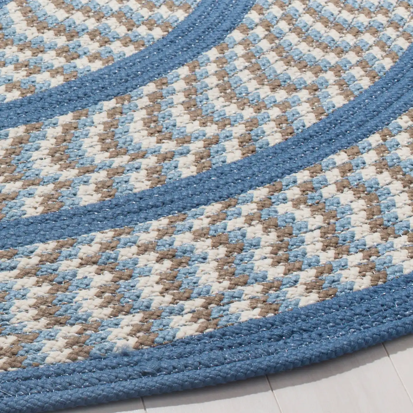 Braided Concentric Oval Hand-Woven Rug in Ivory / Blue in a styled room