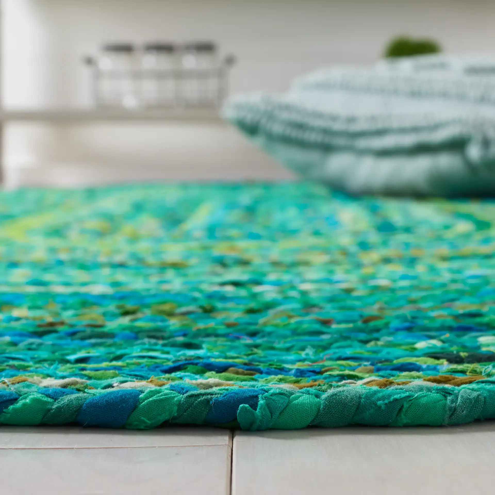 Braided Coastal Spiral Hand-Woven Cotton Rug in Green in a styled room