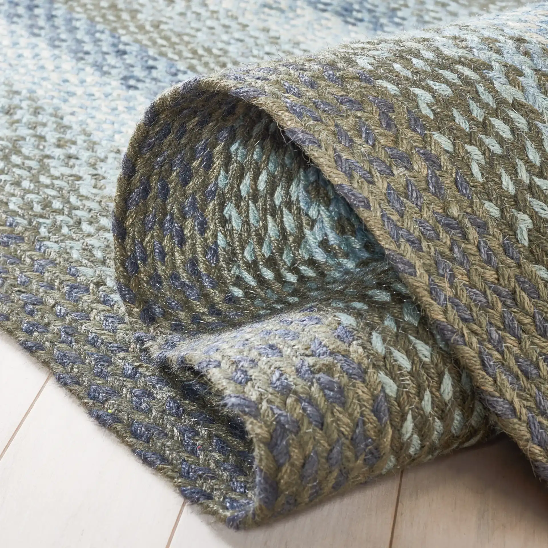 Braided Coastal Geometric Jute Rug in Light Blue / Green in a styled room