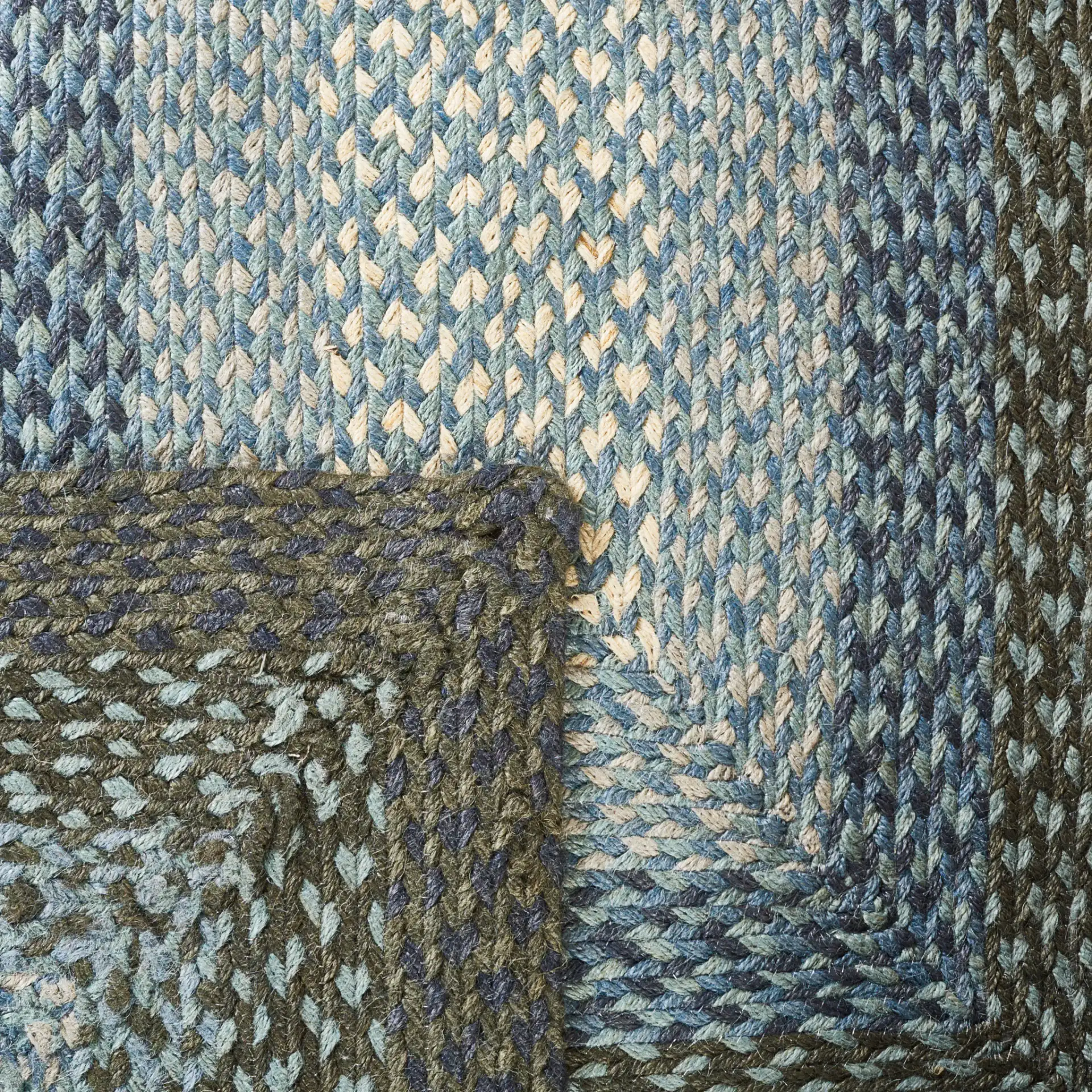 Braided Coastal Geometric Jute Rug in Light Blue / Green in a styled room