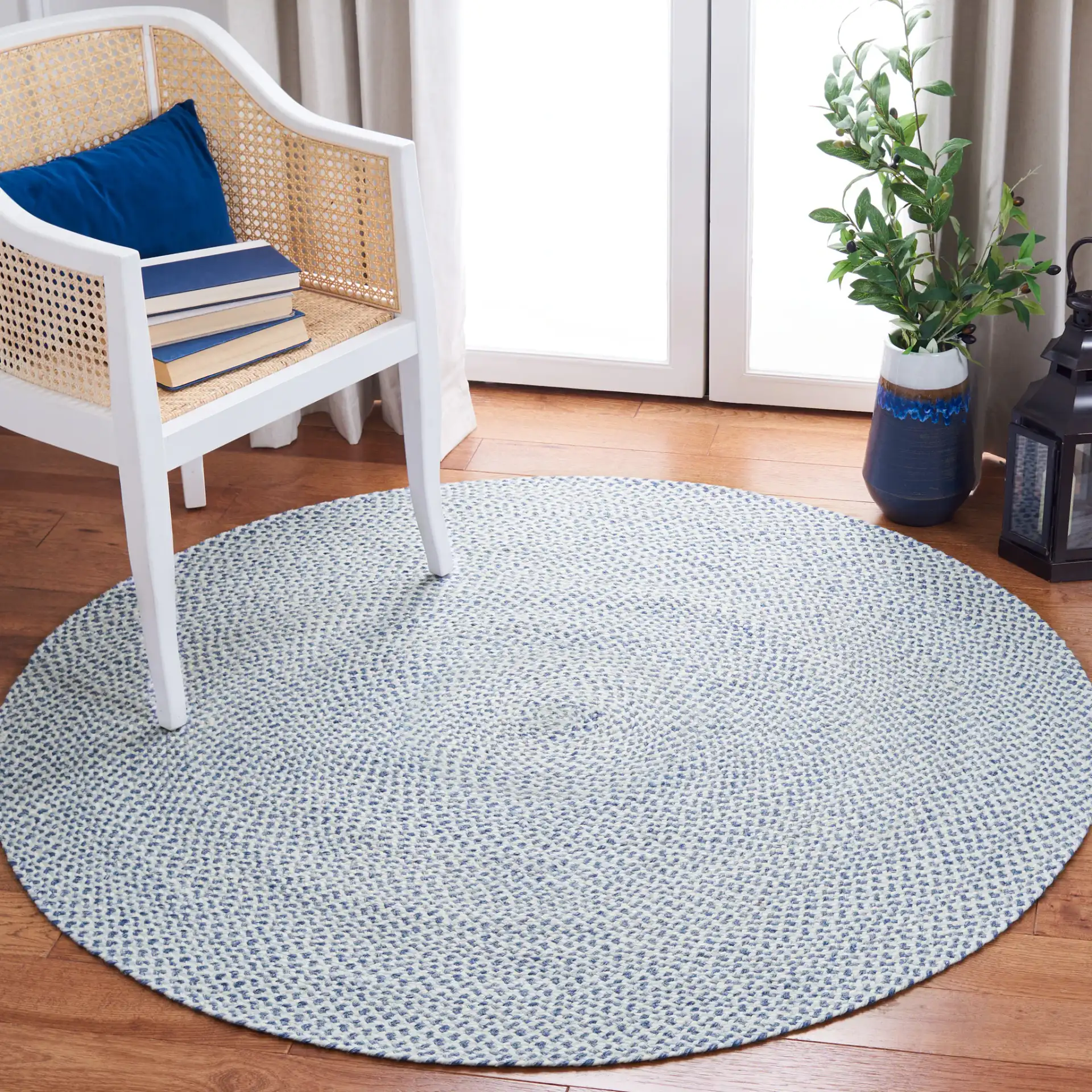 Braided Coastal Flecked Spiral Hand-Woven Rug in Blue / Ivory in a styled room