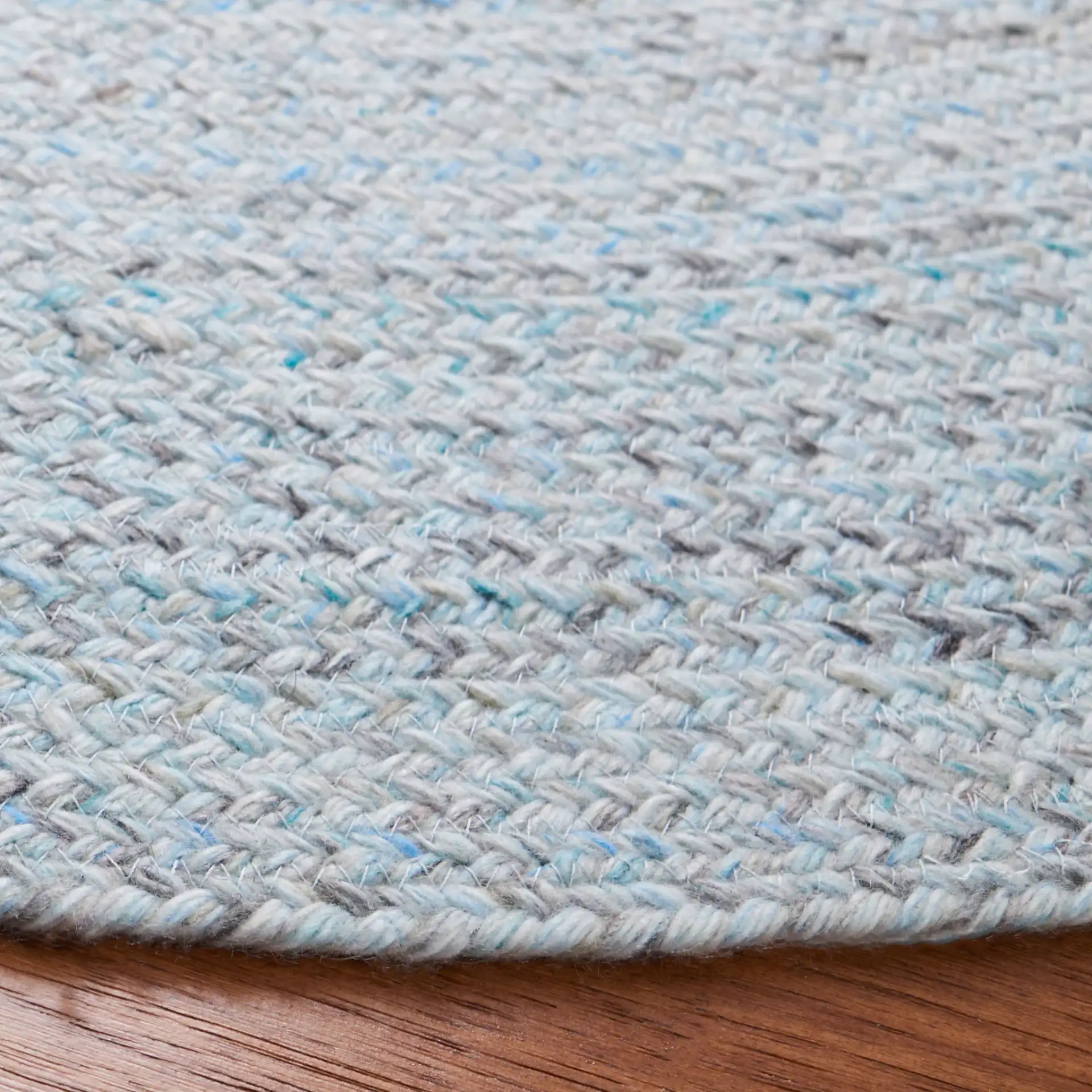 Braided Coastal Solid Rug in Blue / Gray in a styled room