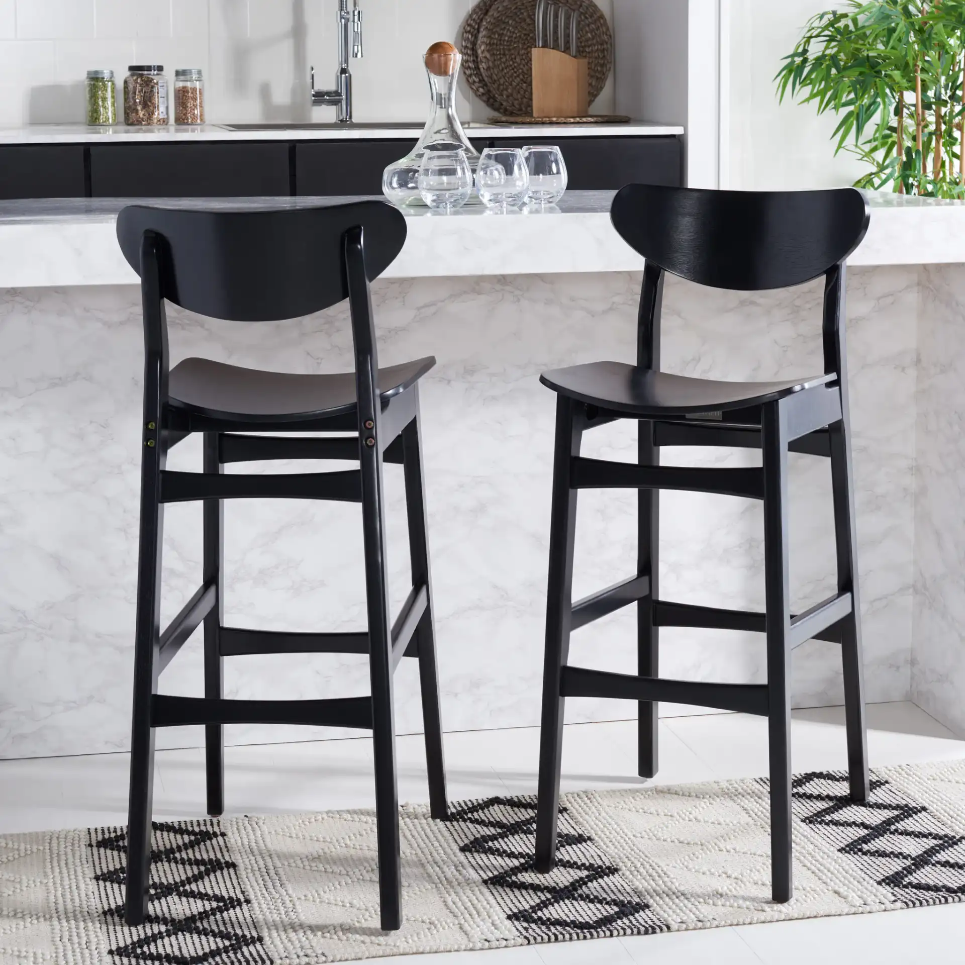 Thaxton Bar Stool (Set of 2) in Black in a styled room