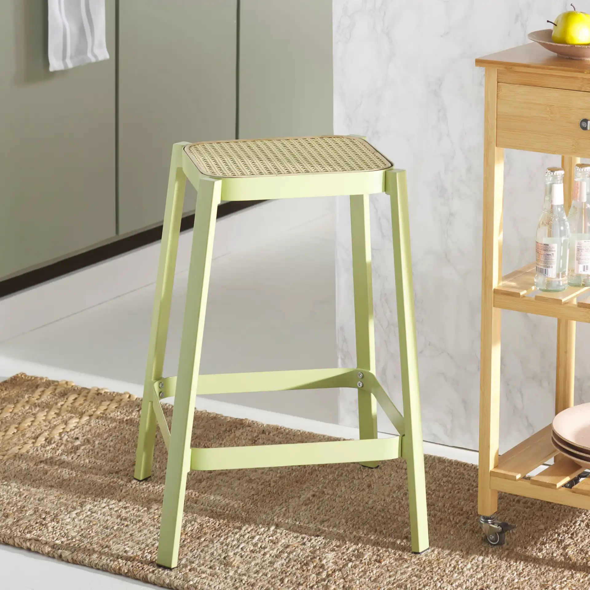 Palmyra Cane Counter Stool in Green / Natural in a styled room