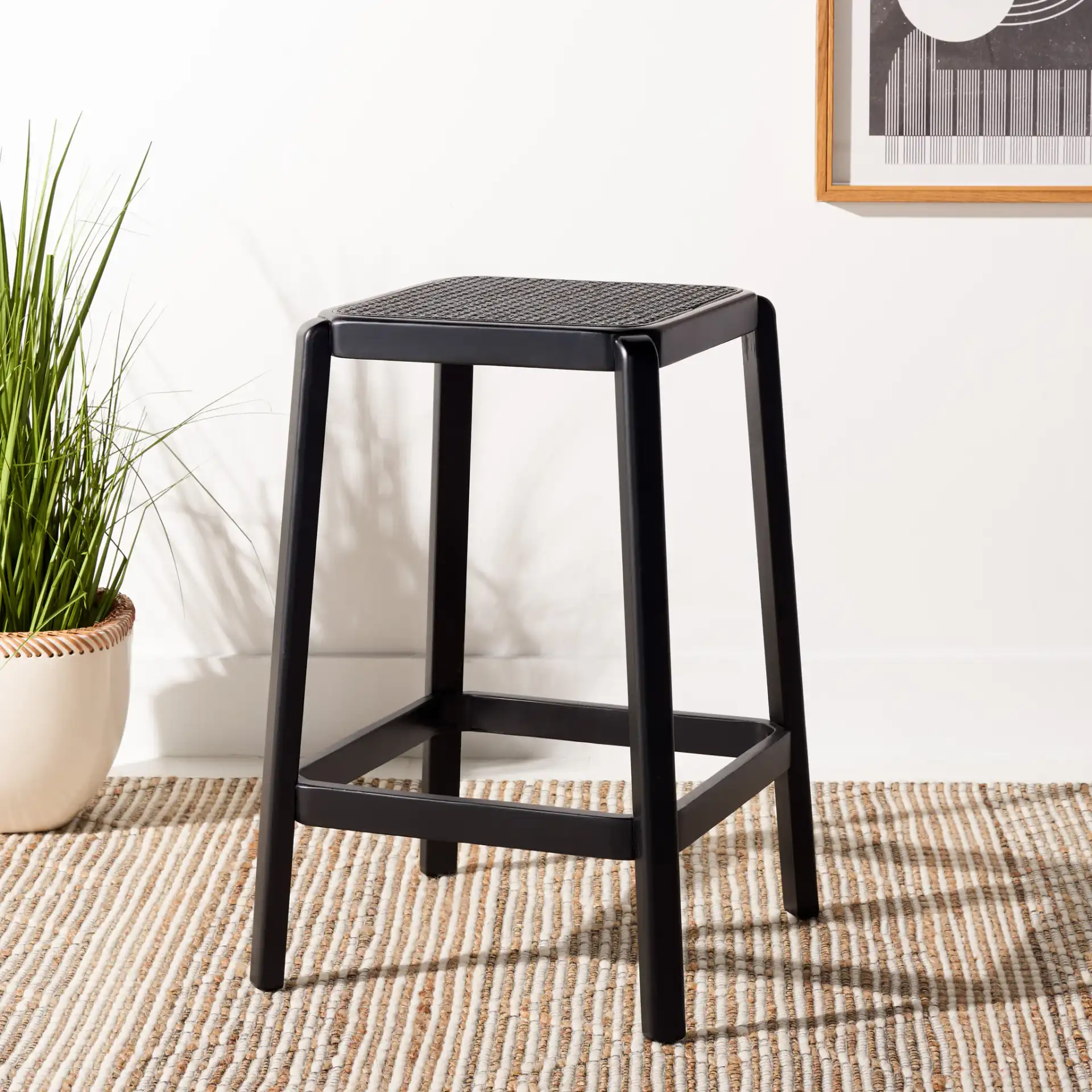 Silus Backless Cane Counter Stool in Black in a styled room