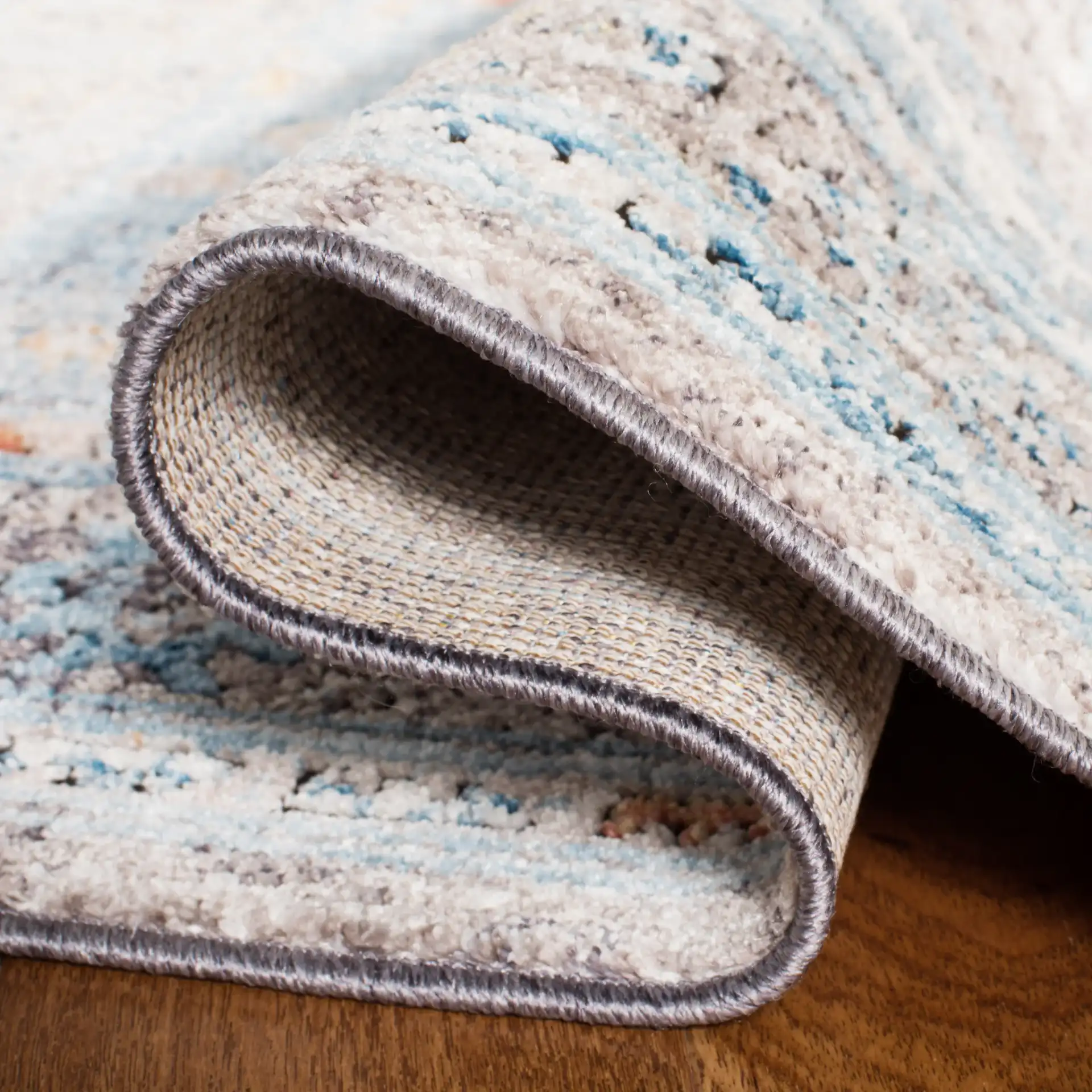Bristol Stepped Medallion Rug in Gray / Blue in a styled room