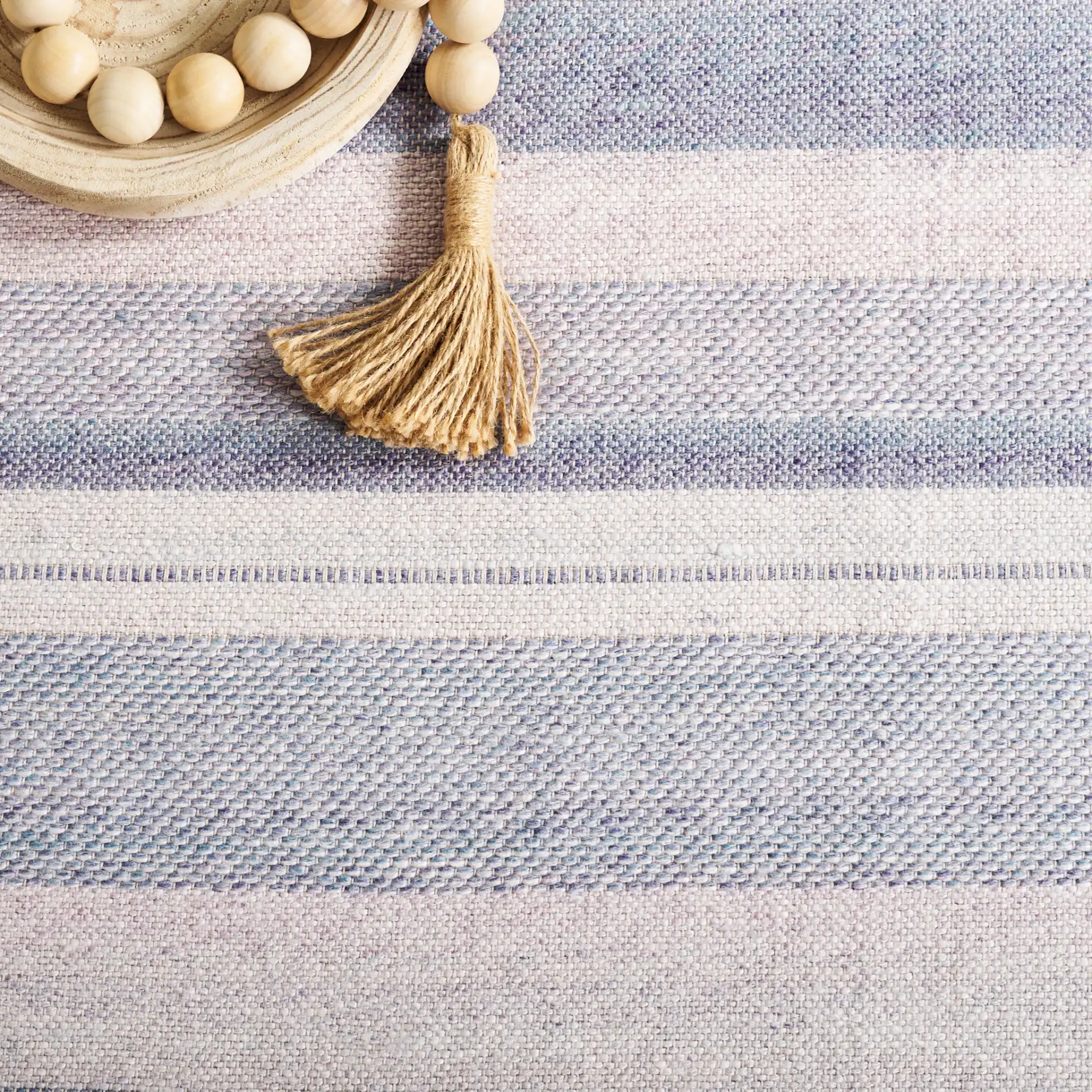 Cabo Striped Border Rug in Blue / Purple in a styled room