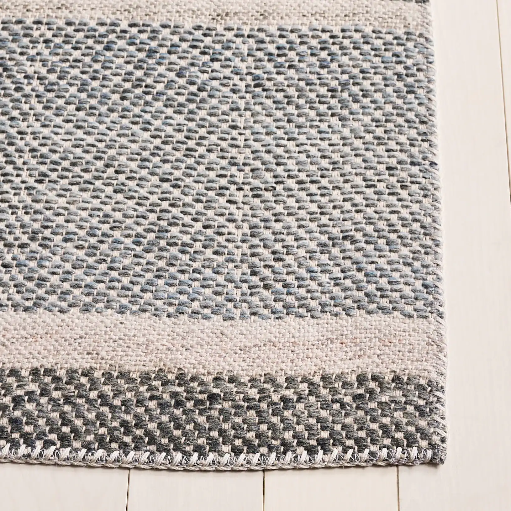 Cabo Striped Rug in Black / Light Blue in a styled room
