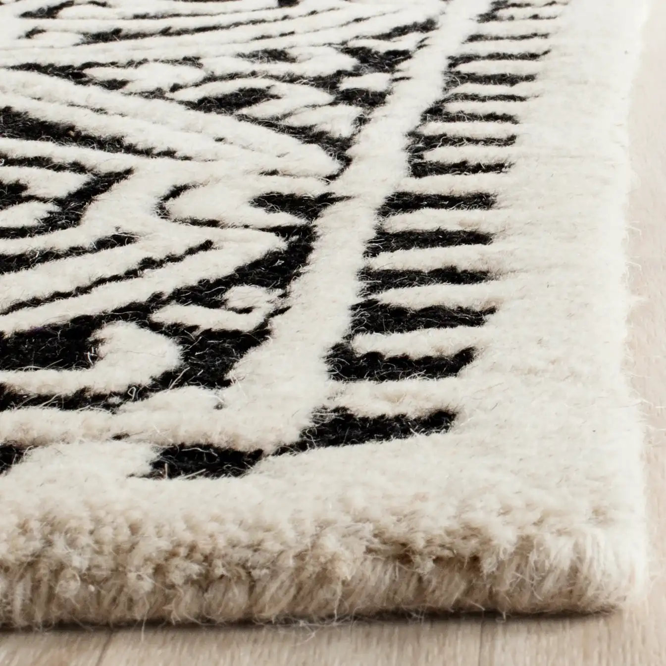 Cambridge Tile Hand-Tufted Wool Rug in Black / Ivory in a styled room