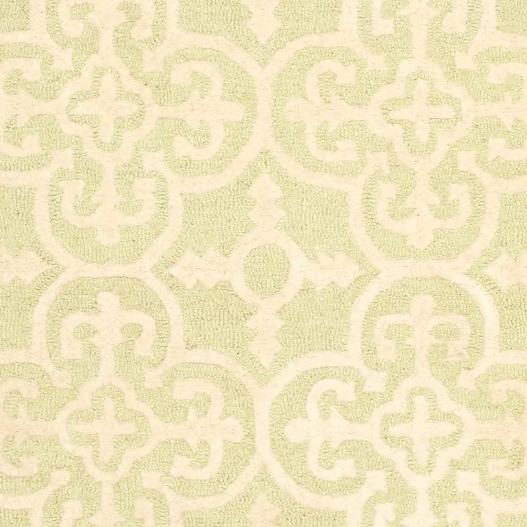 Cambridge Ornate Quatrefoil Hand-Tufted Wool Rug in Light Green / Ivory in a styled room