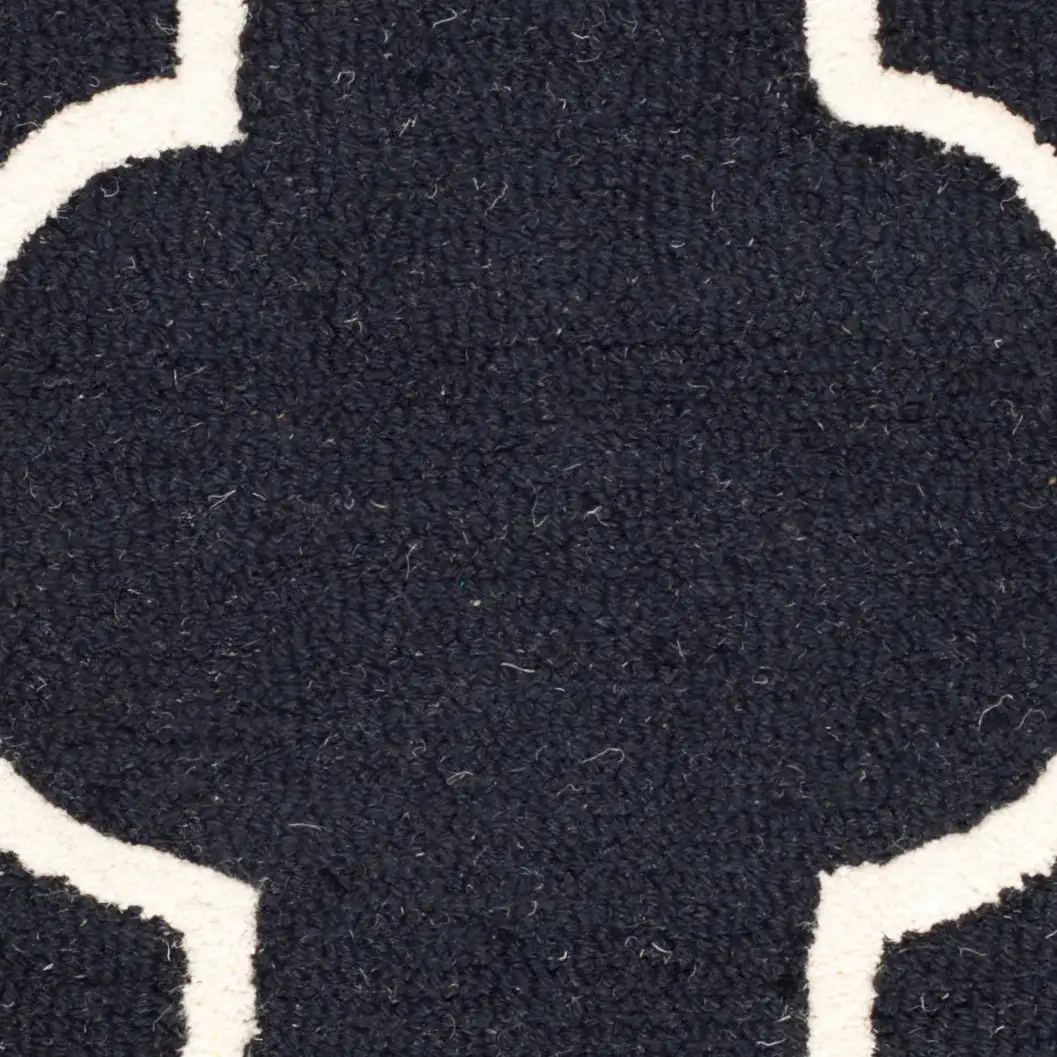 Cambridge Ogee Trellis Hand-Tufted Wool Rug in Black / Ivory in a styled room