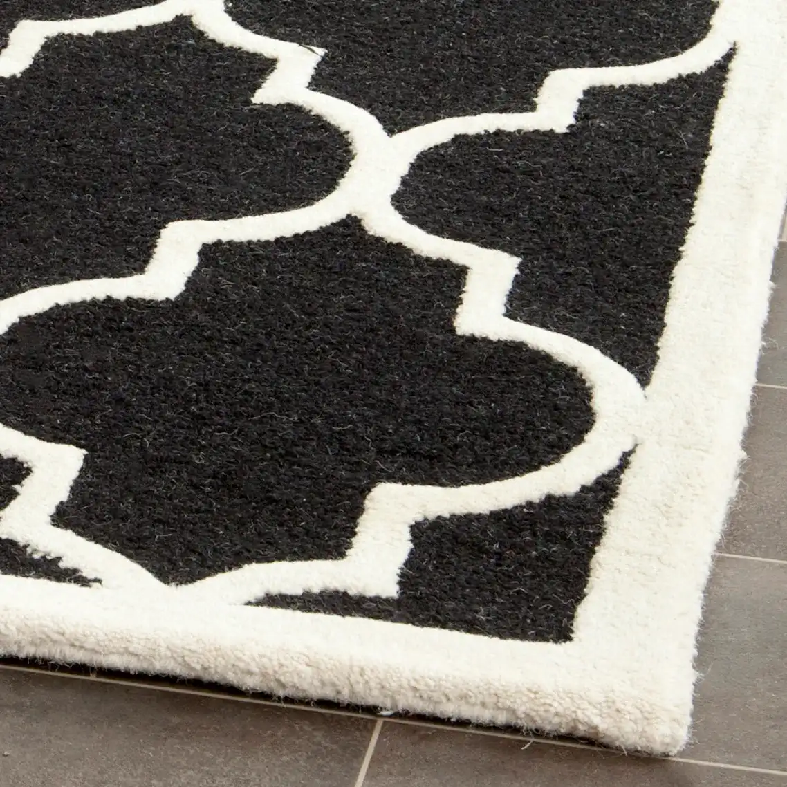 Cambridge Ogee Trellis Hand-Tufted Wool Rug in Black / Ivory in a styled room