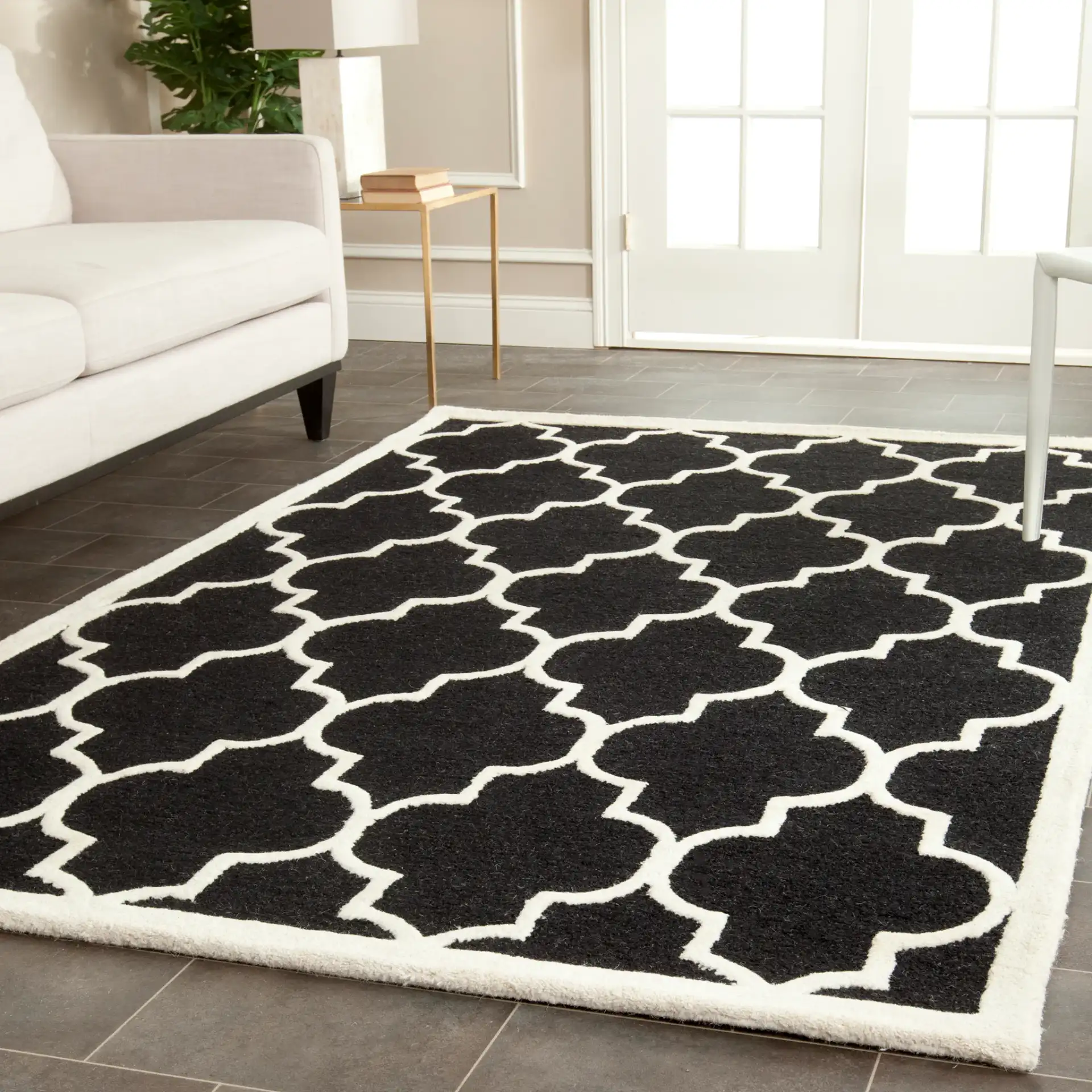 Cambridge Ogee Trellis Hand-Tufted Wool Rug in Black / Ivory in a styled room