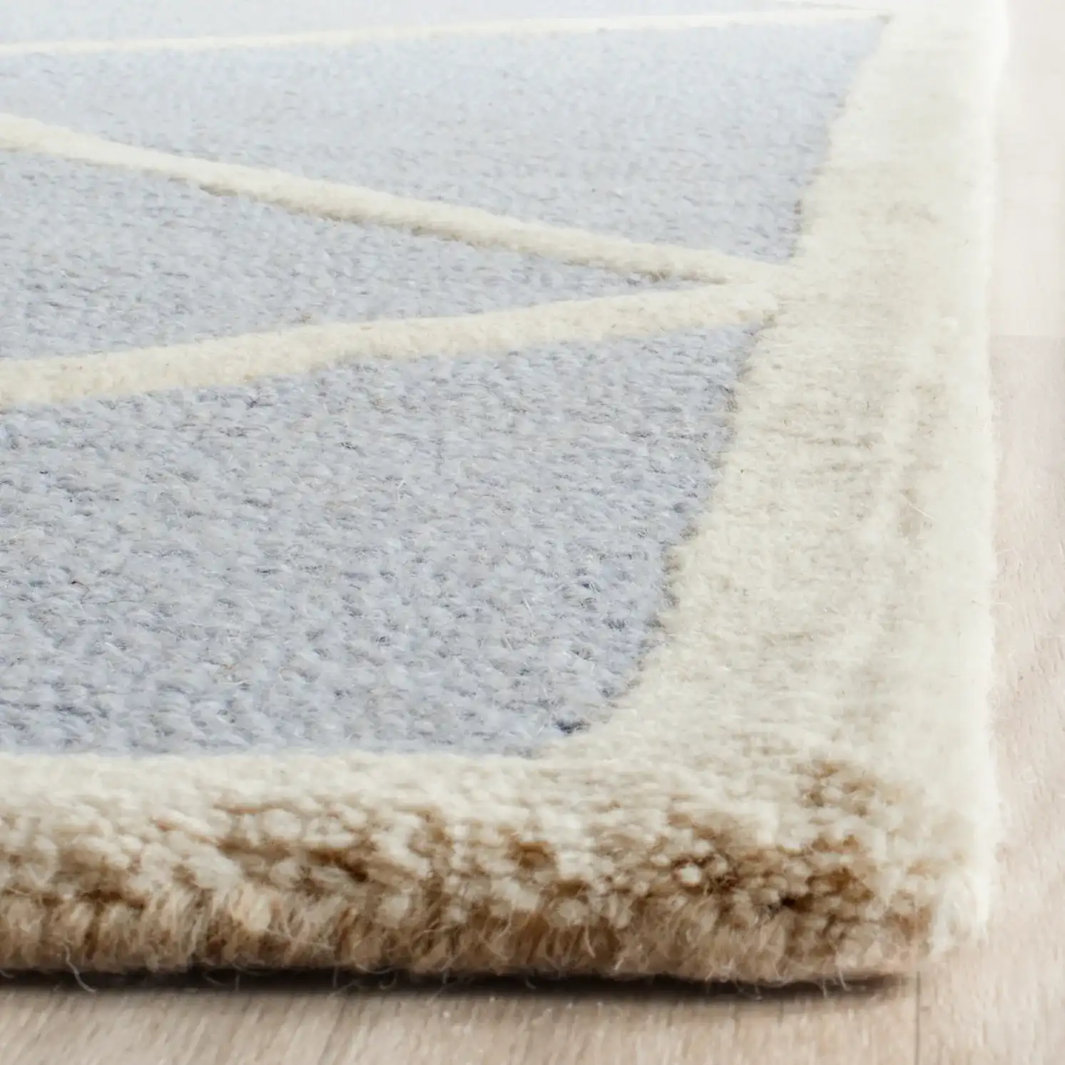 Cambridge Diamond Trellis Hand-Tufted Wool Rug in Light Blue / Ivory in a styled room
