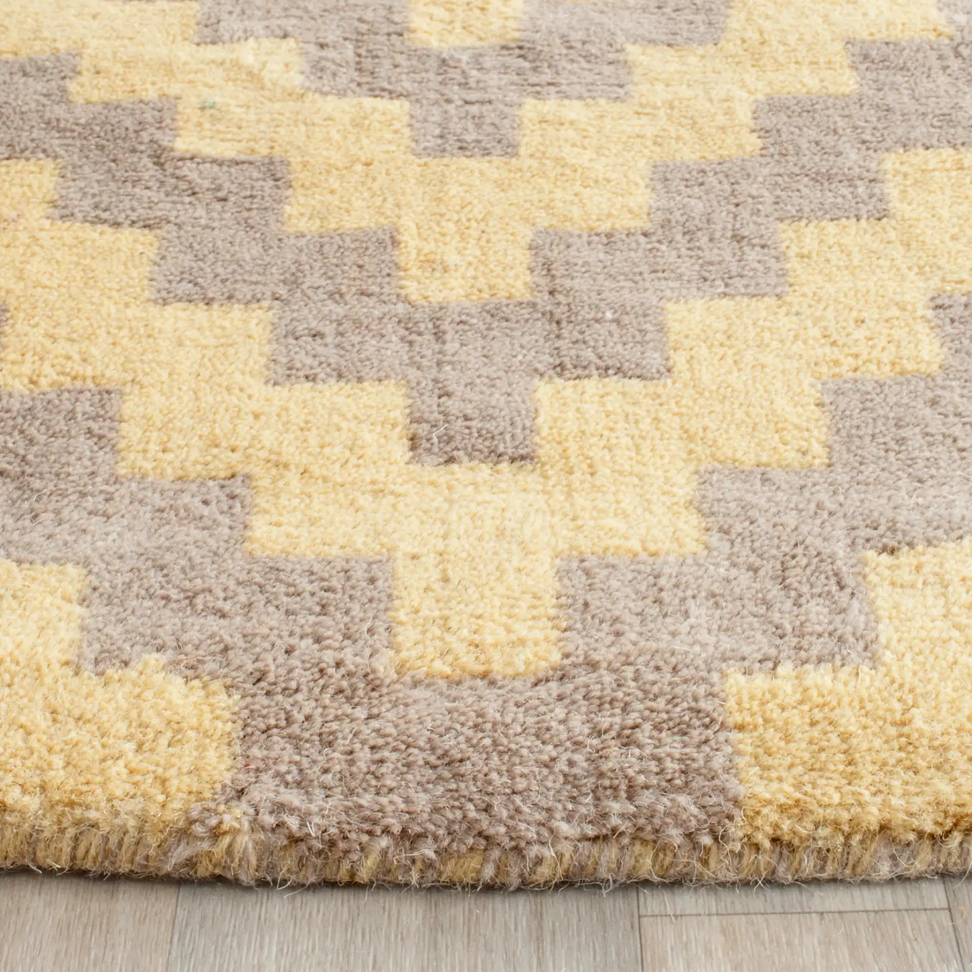 Cambridge Stepped Chevron Hand-Tufted Wool Rug in Taupe / Gold in a styled room
