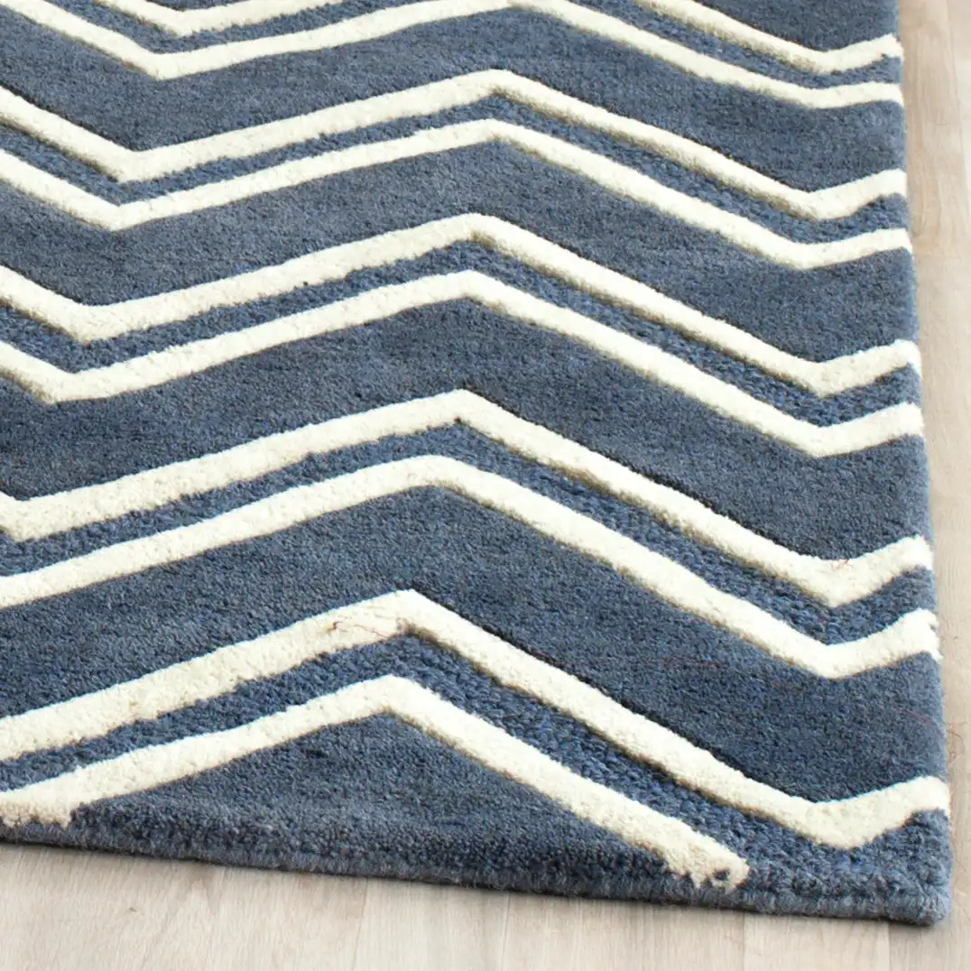 Cambridge Double Chevron Hand-Tufted Wool Rug in Navy / Ivory in a styled room