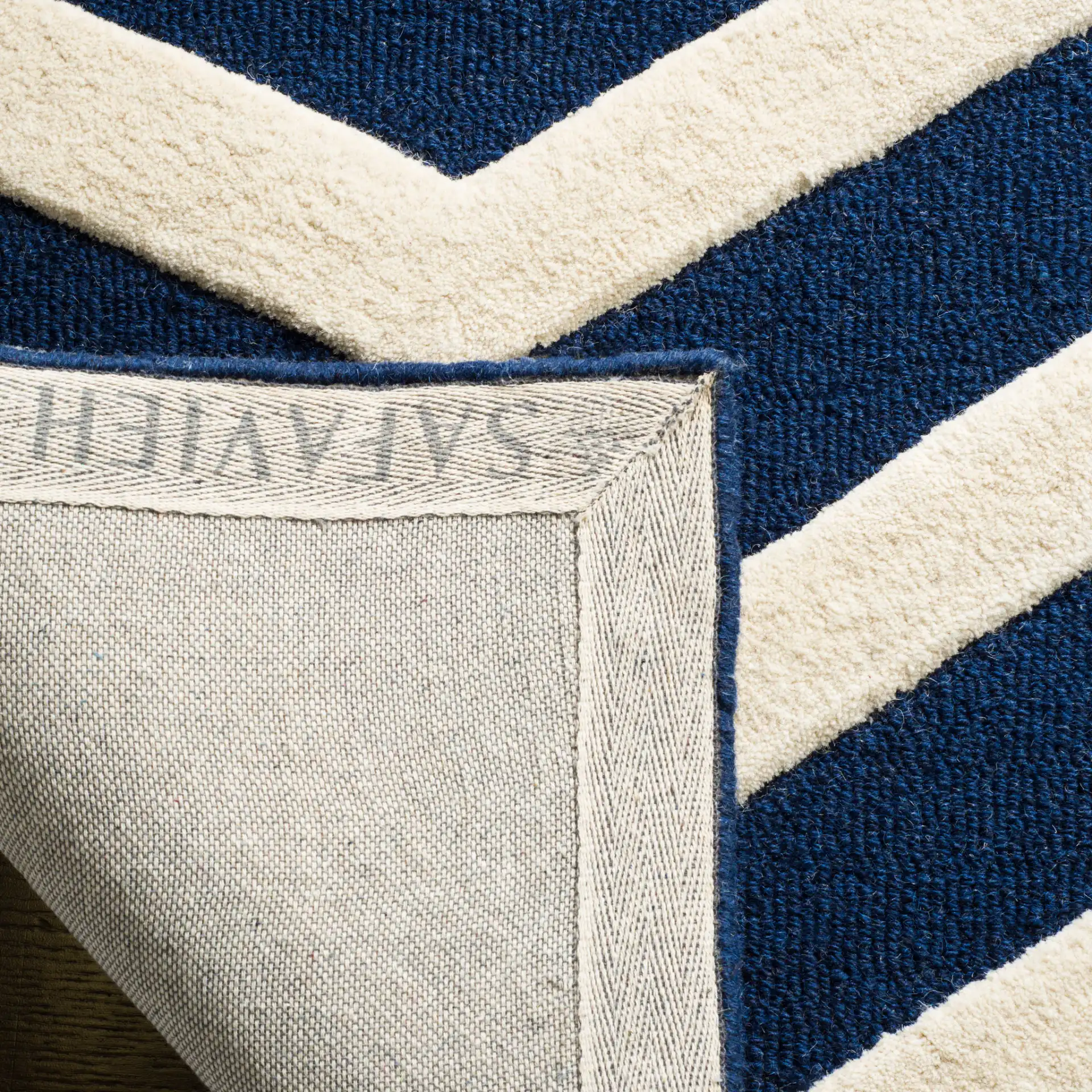 Cambridge Textured Chevron Hand-Tufted Wool Rug in Navy / Ivory in a styled room