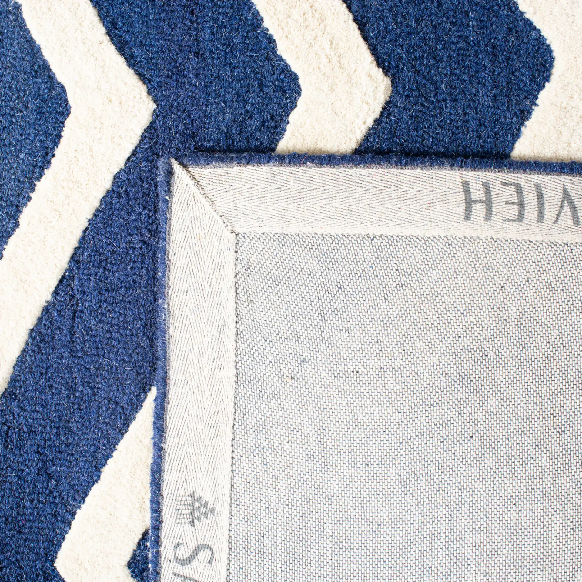 Cambridge Textured Chevron Hand-Tufted Wool Rug in Navy / Ivory in a styled room