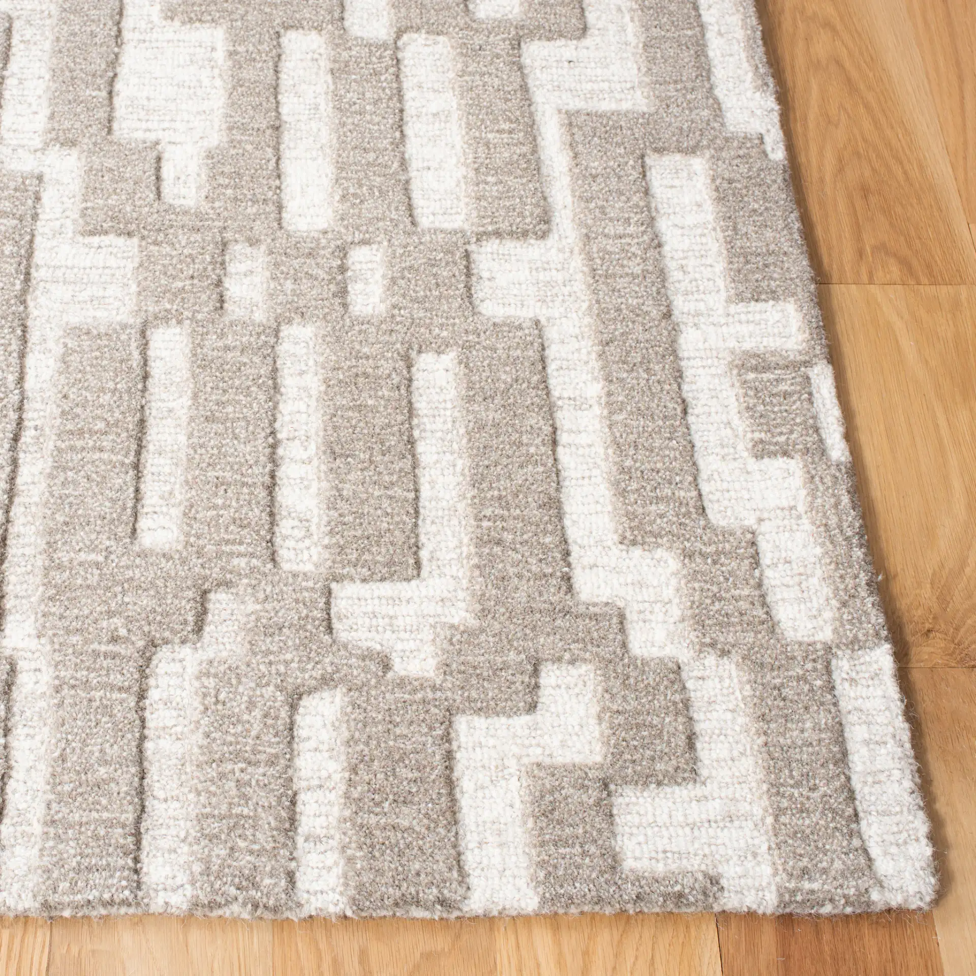 Cambridge Stepped Block Hand-Tufted Wool Rug in Beige / Gray in a styled room