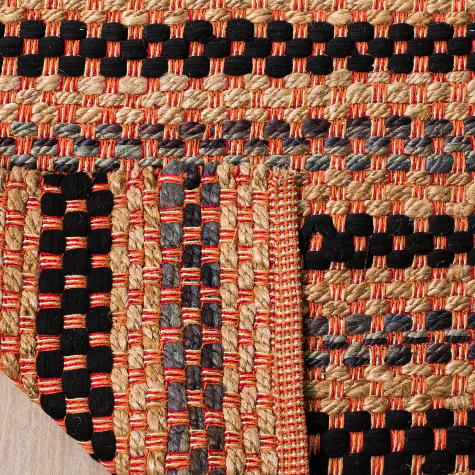 Cape Cod Woven Dash Stripe Hand-Woven Rug in Orange / Black in a styled room