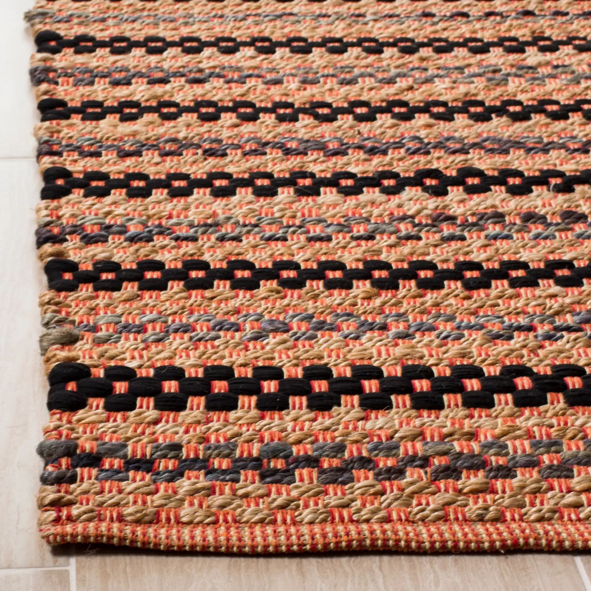 Cape Cod Woven Dash Stripe Hand-Woven Rug in Orange / Black in a styled room