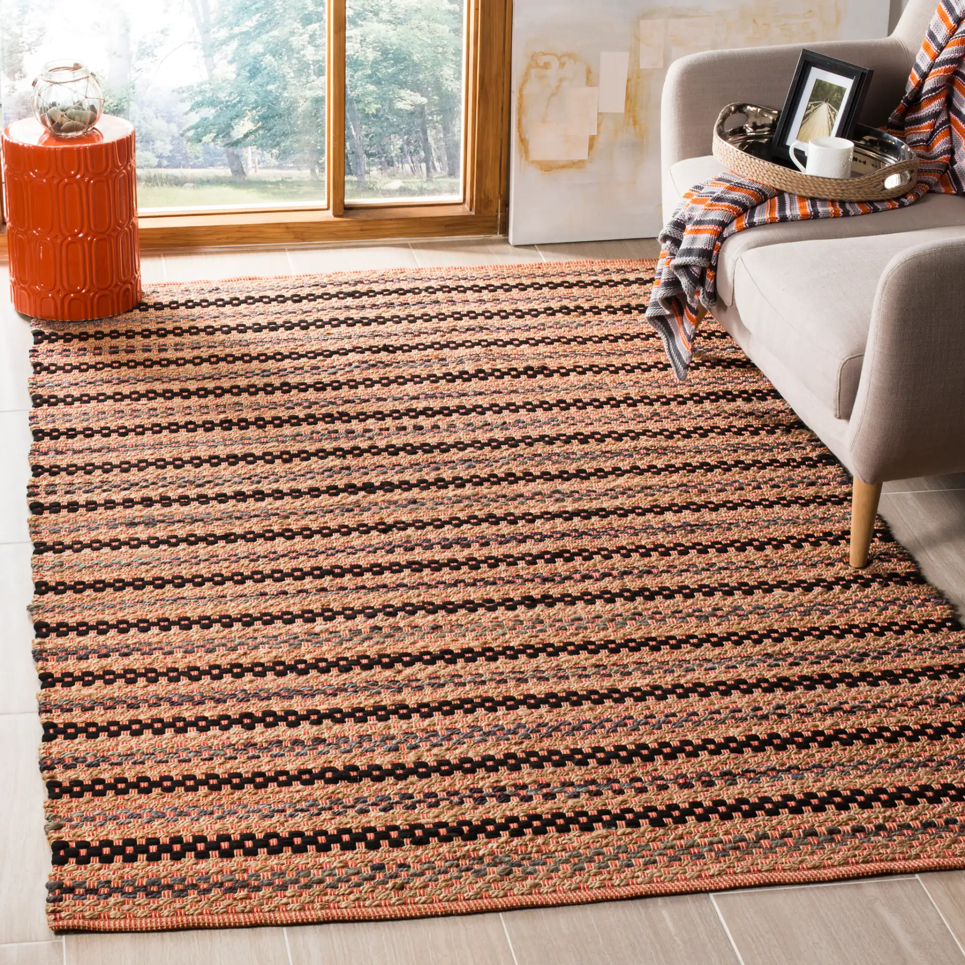 Cape Cod Woven Dash Stripe Hand-Woven Rug in Orange / Black in a styled room