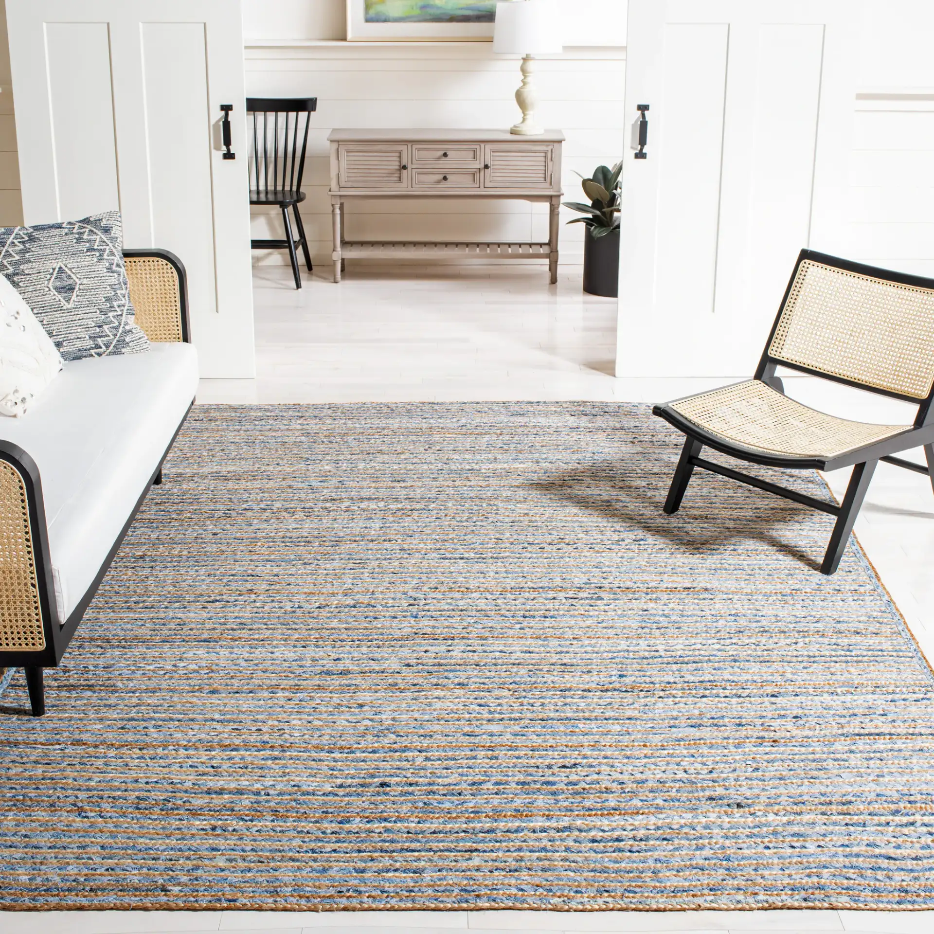Cape Cod Braided Stripe Hand-Woven Rug in Natural / Blue in a styled room