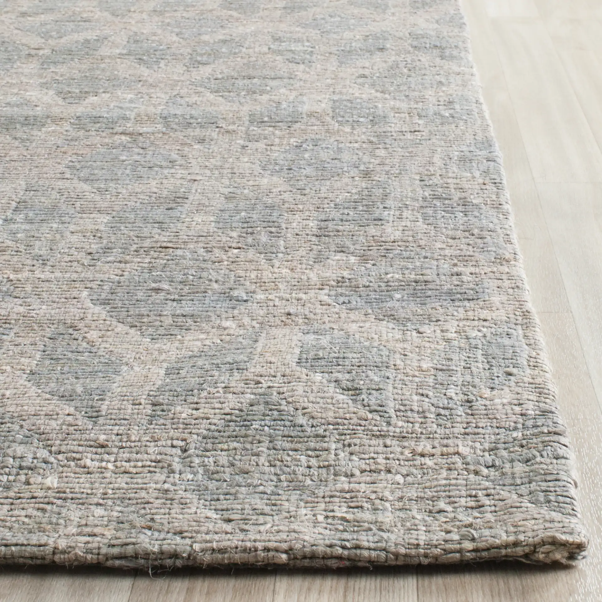 Cape Cod Diamond Hand-Woven Jute Rug in Gray / Gold in a styled room
