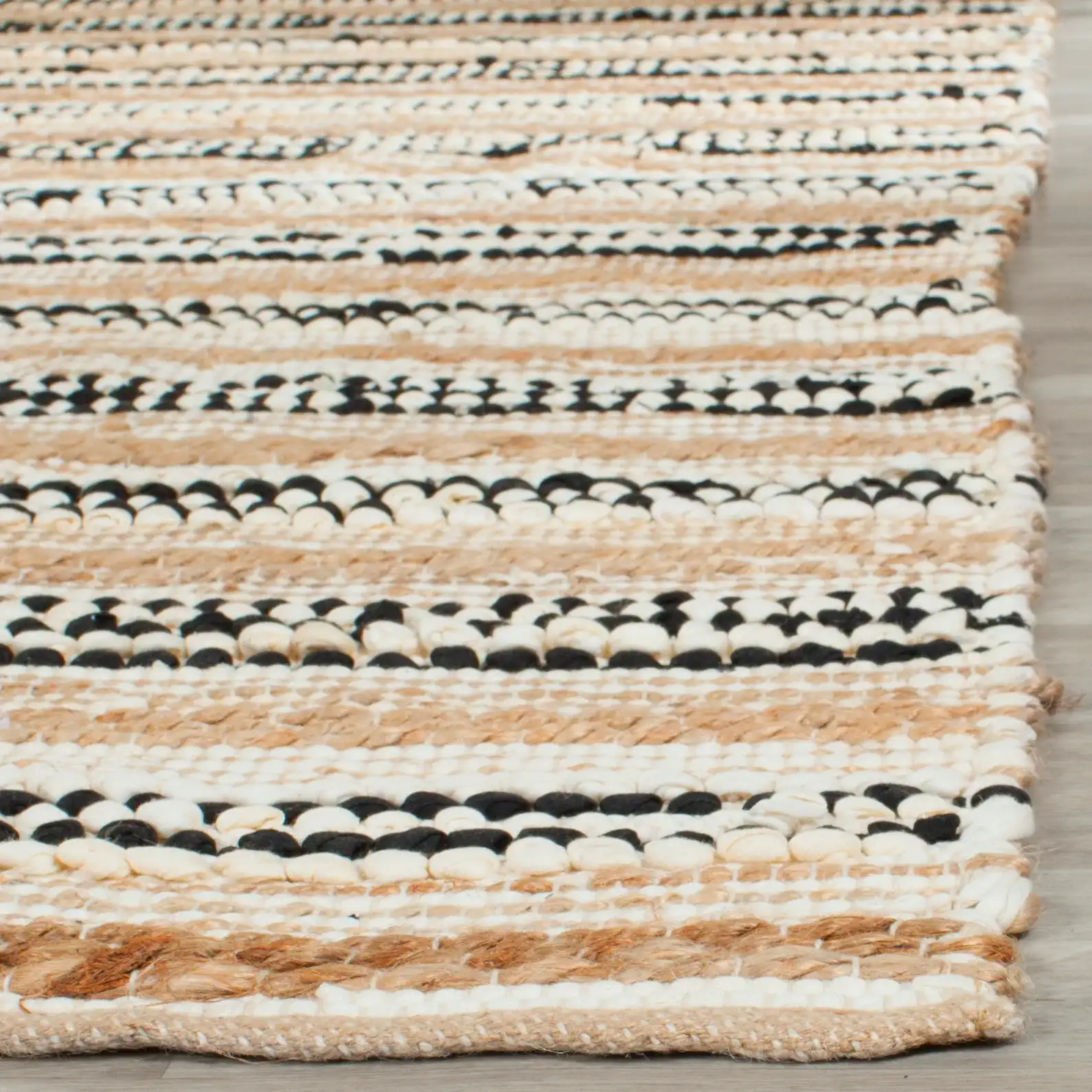 Cape Cod Varied Stripe Hand-Woven Rug in Natural / Black in a styled room