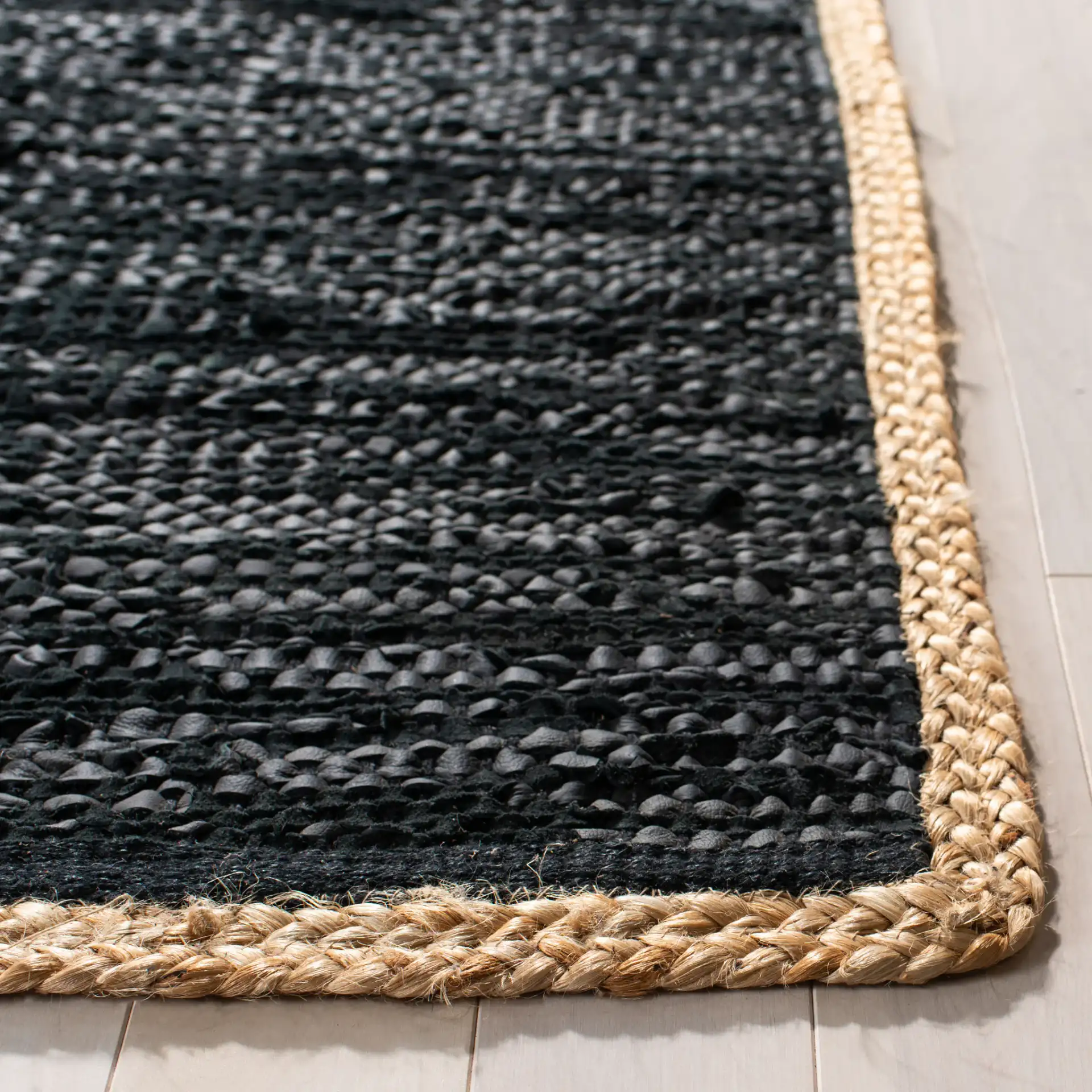 Cape Cod Bordered Hand-Woven Leather Rug in Black / Natural in a styled room