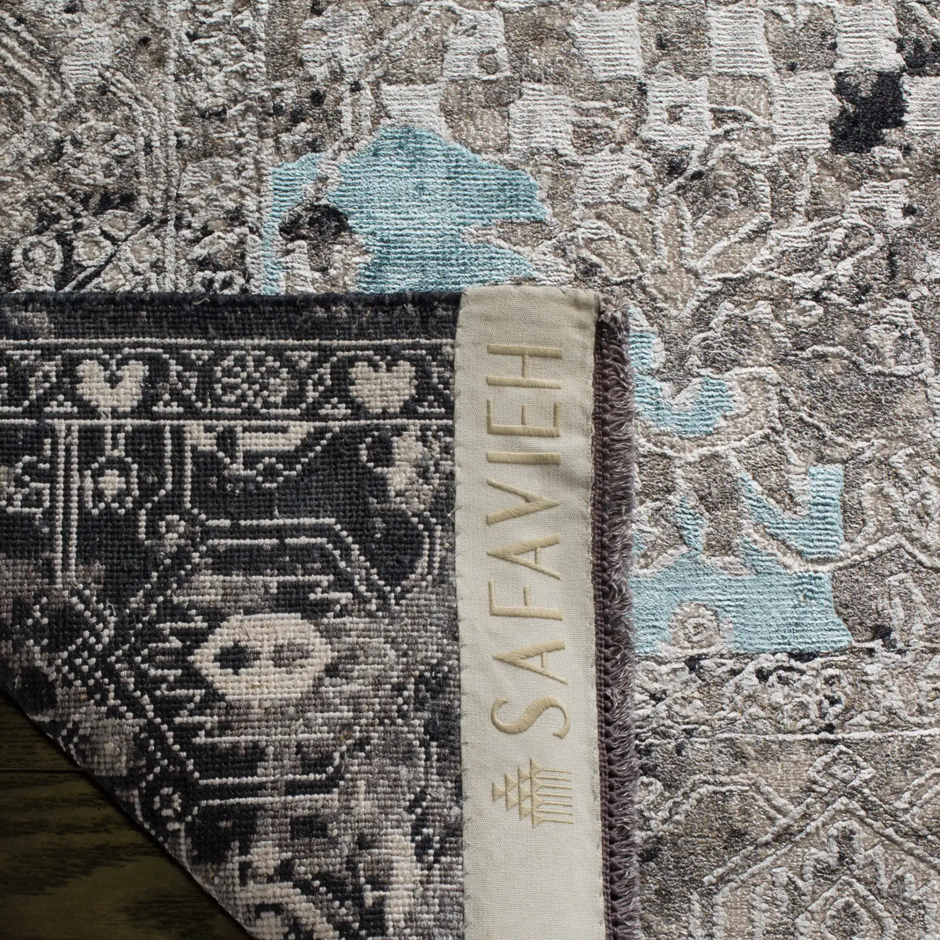 Centennial Distressed Border Hand-Knotted Rug in Light Blue in a styled room