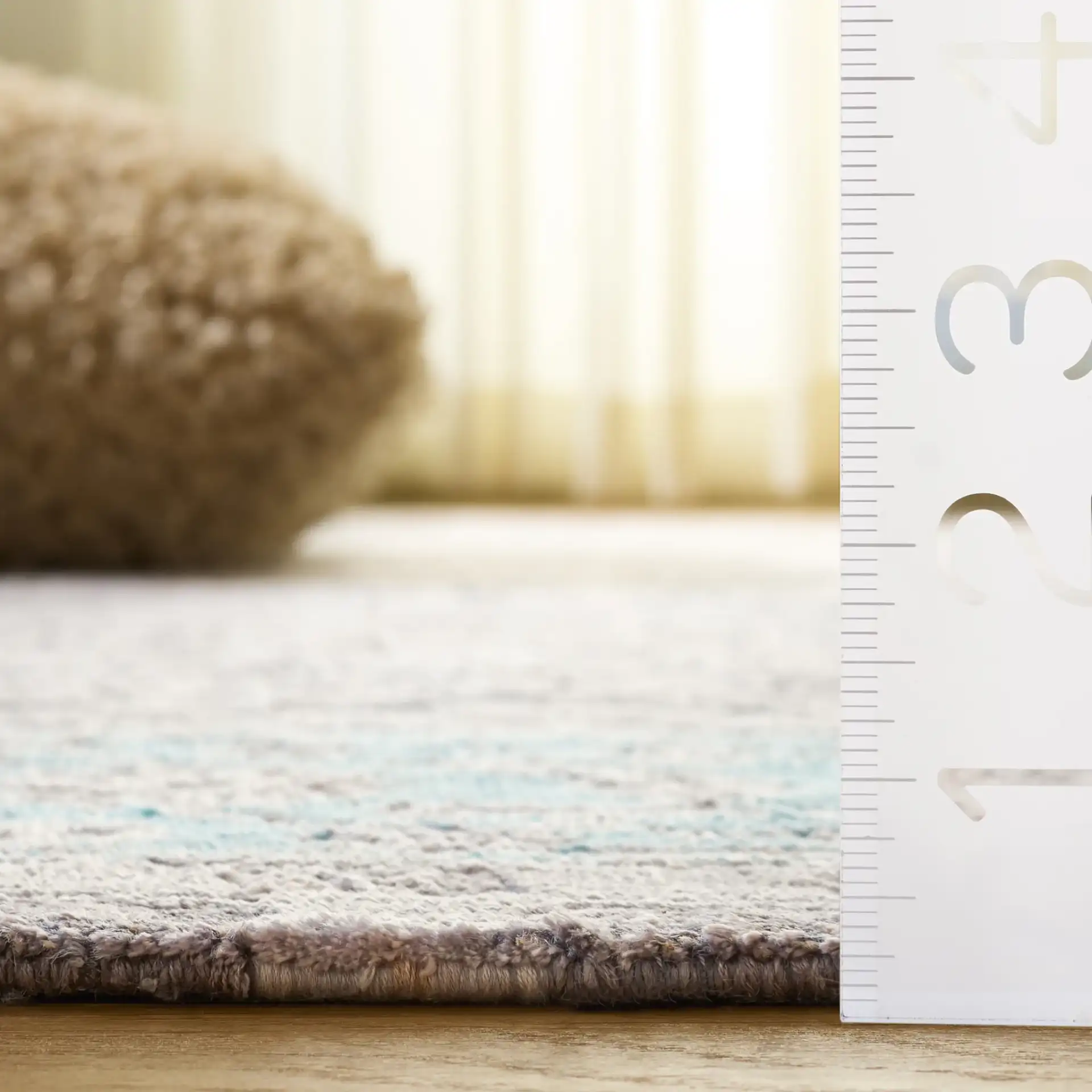 Centennial Distressed Border Hand-Knotted Rug in Light Blue in a styled room