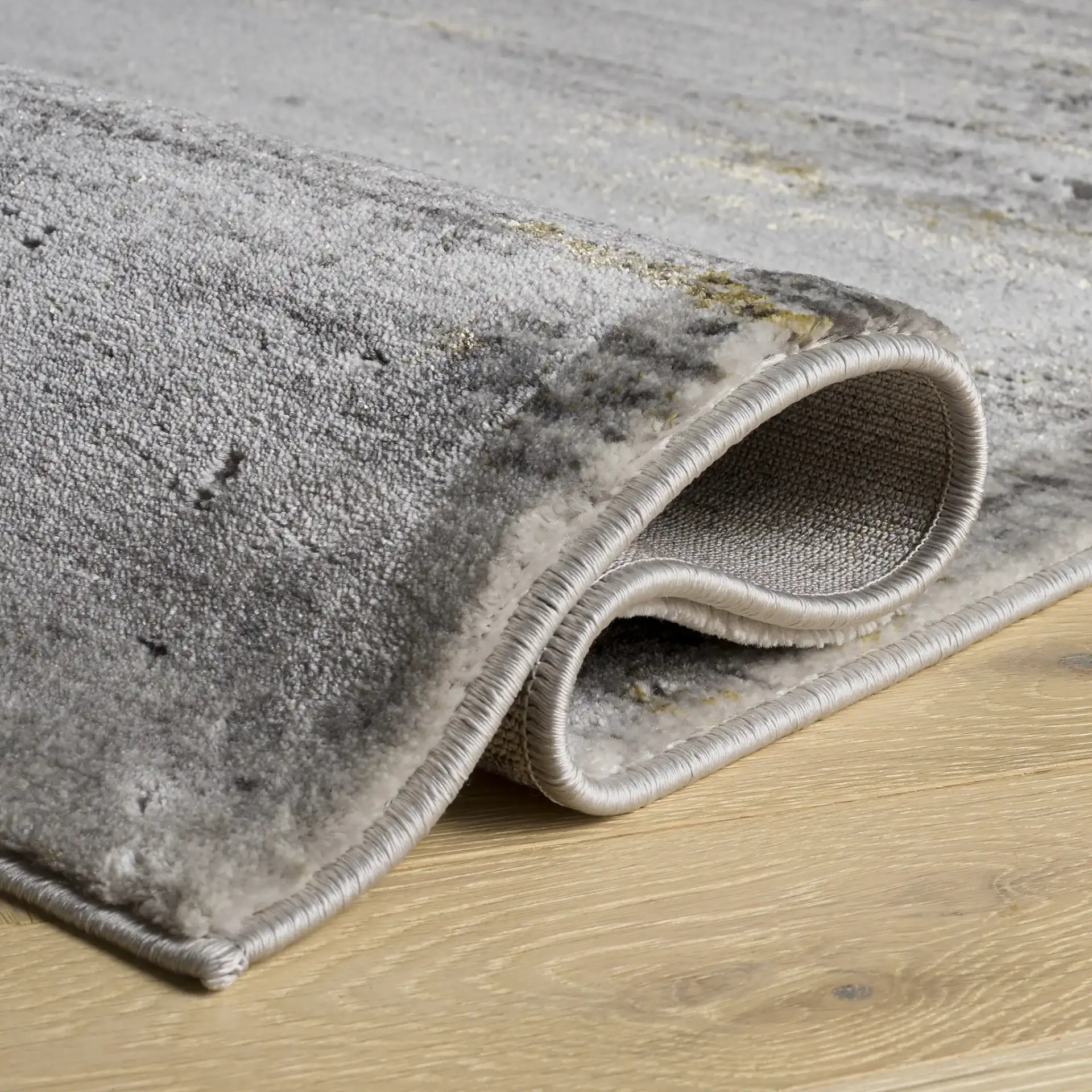 Craft Modern Abstract Rug in Gray / Gold in a styled room