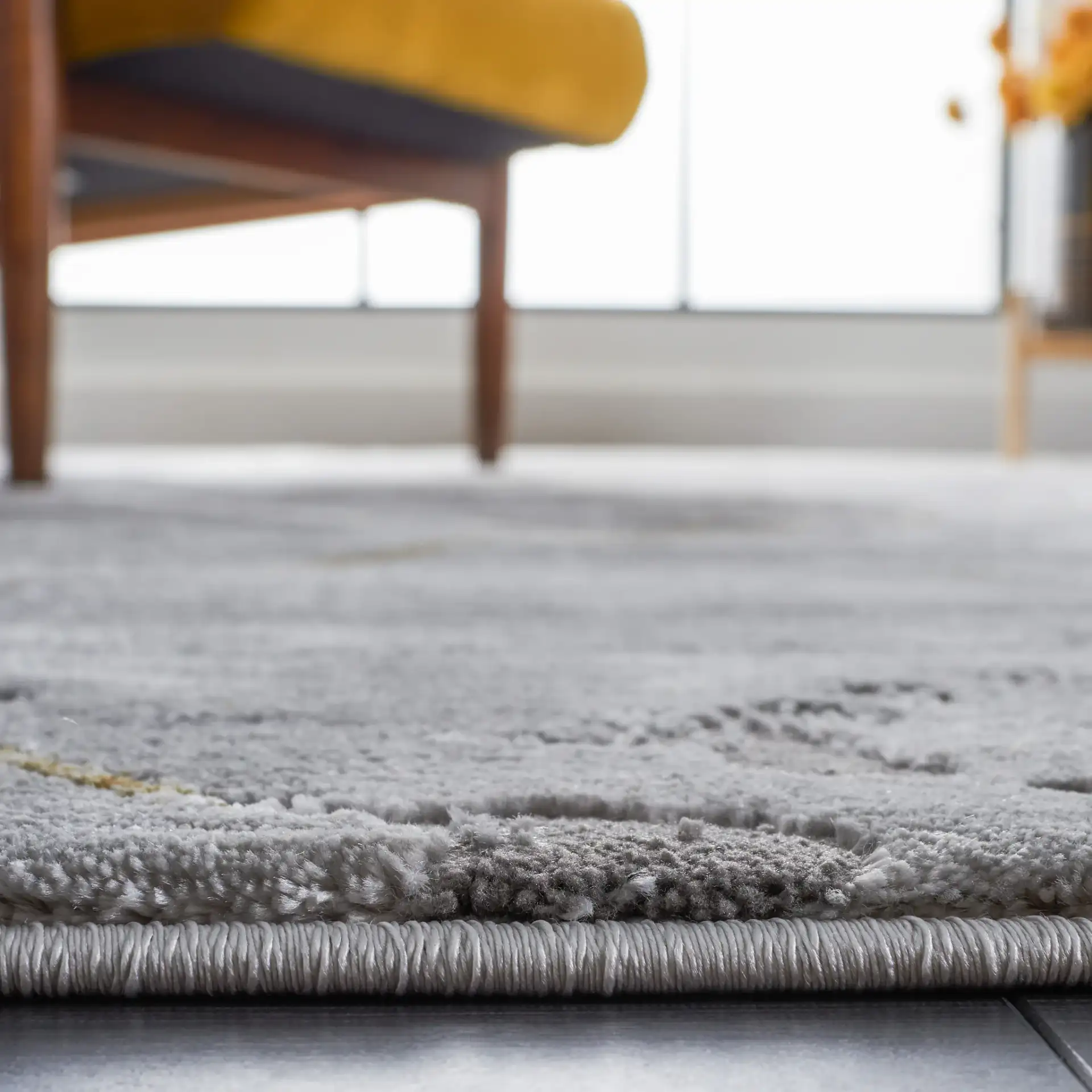 Craft Diamond Grid Rug in Gray / Gold in a styled room