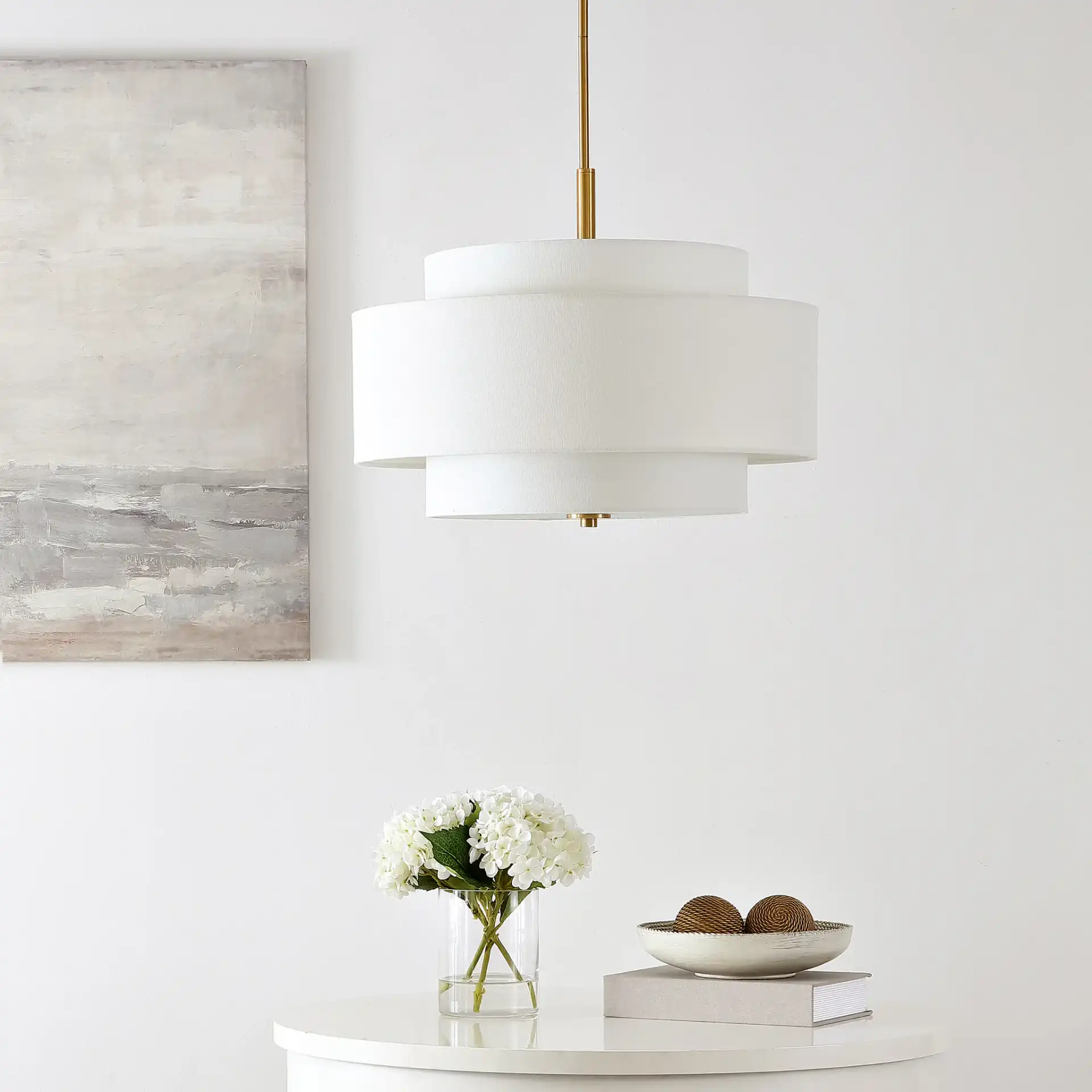 Cambrie Three-Light Chandelier in White / Brass in a styled room
