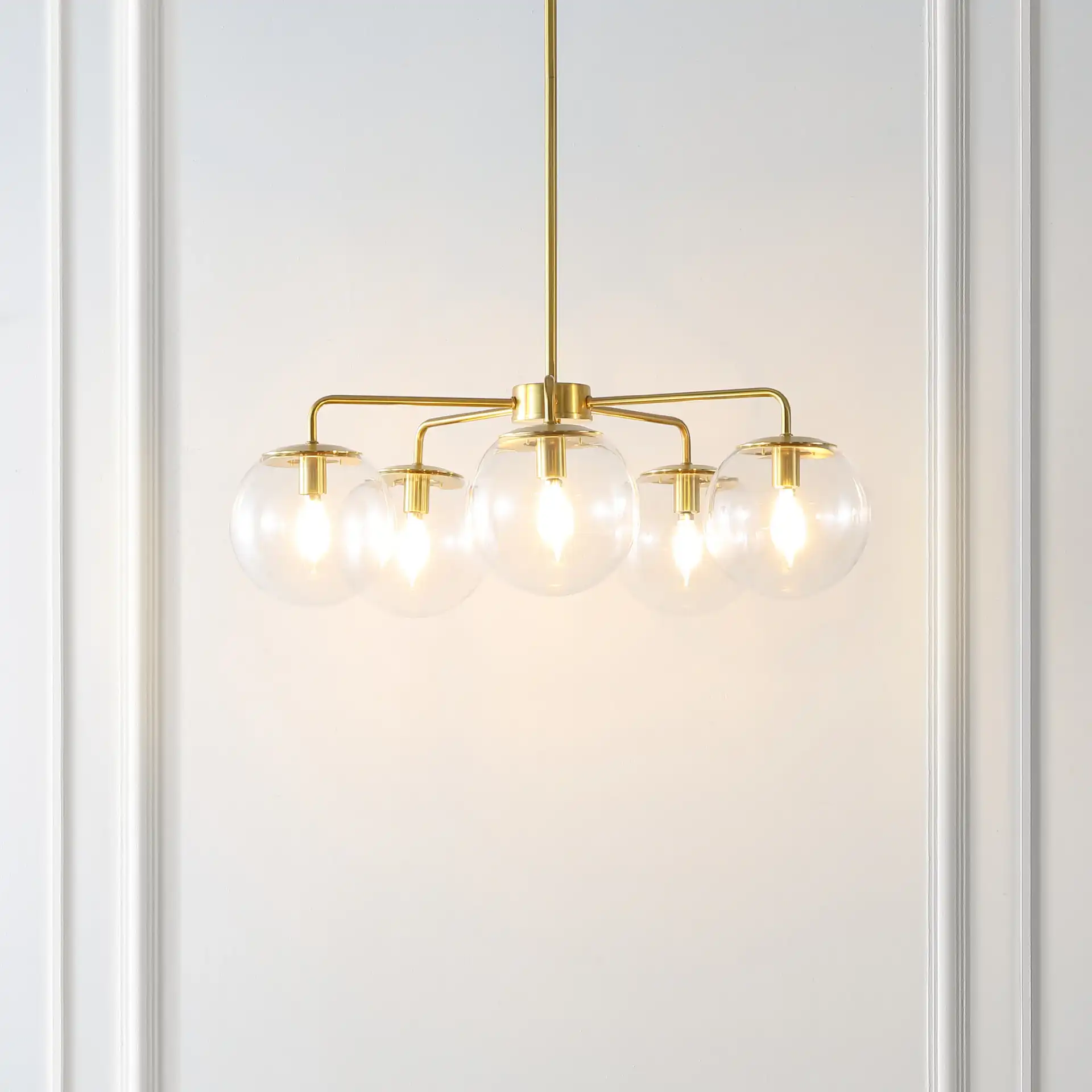 Negara Five-Light Chandelier in Brass / Clear in a styled room